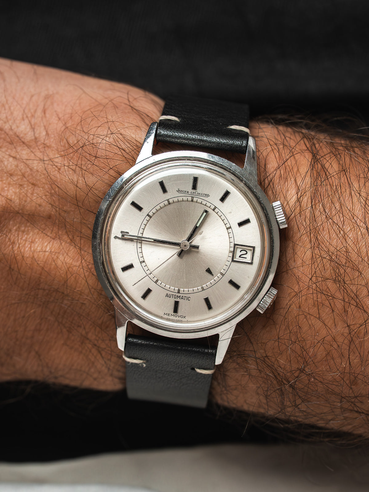 Vintage Jaeger-LeCoultre Memovox Watch aus Stahl, silberfarbenes Zifferblatt, schwarzes Lederarmband am Handgelenk