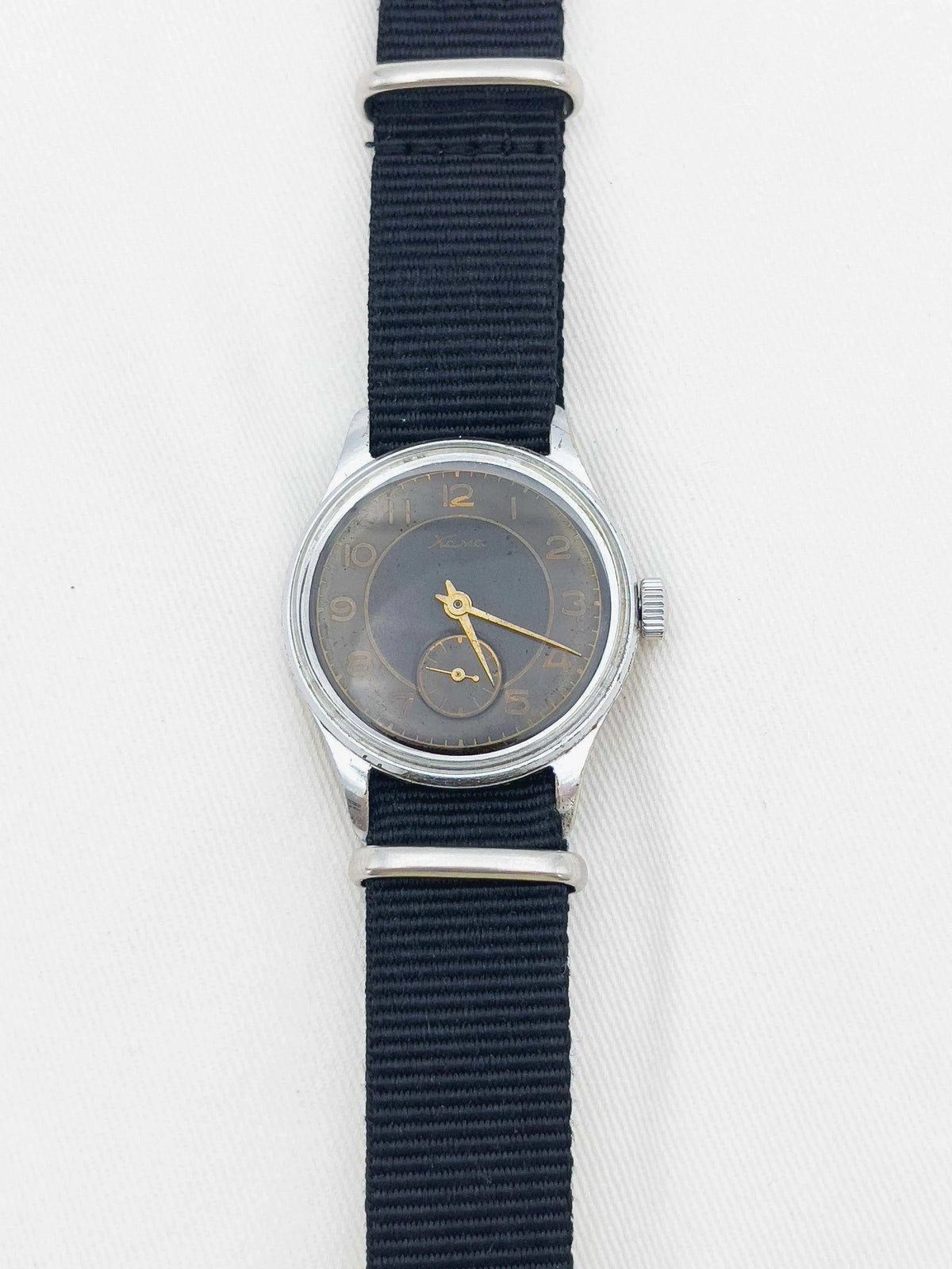 Vintage Xera watch with gray dial, gold hands, steel case, black NATO strap