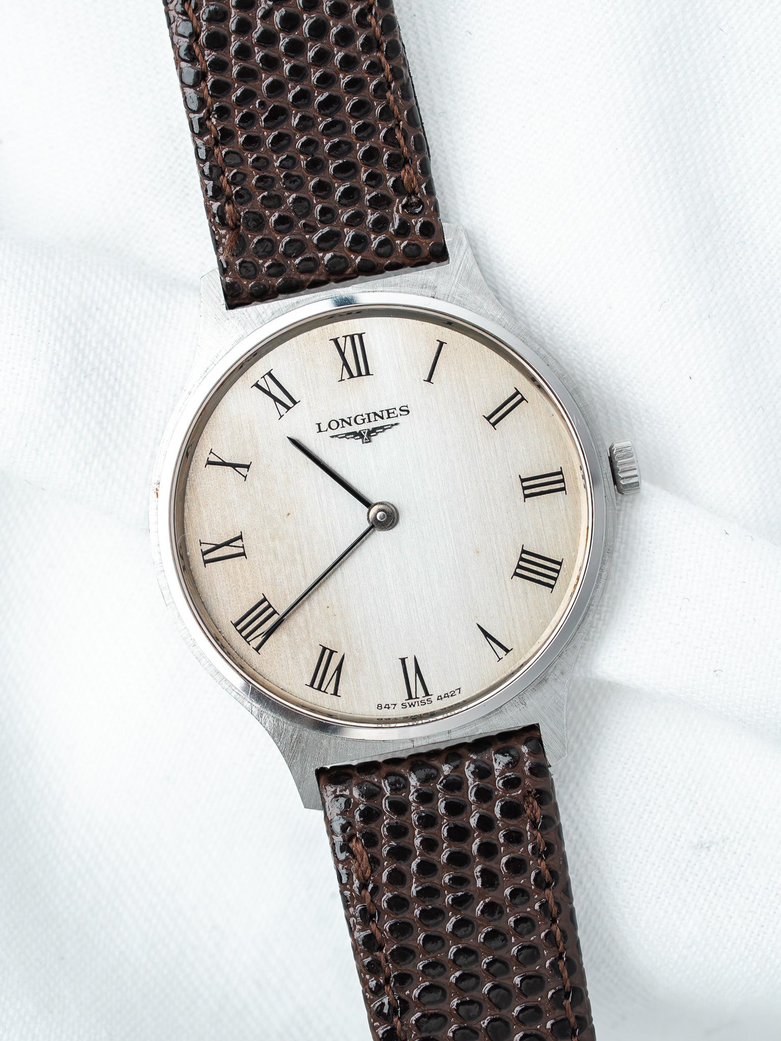 Longines vintage watch with silver dial, Roman numerals, brown textured strap