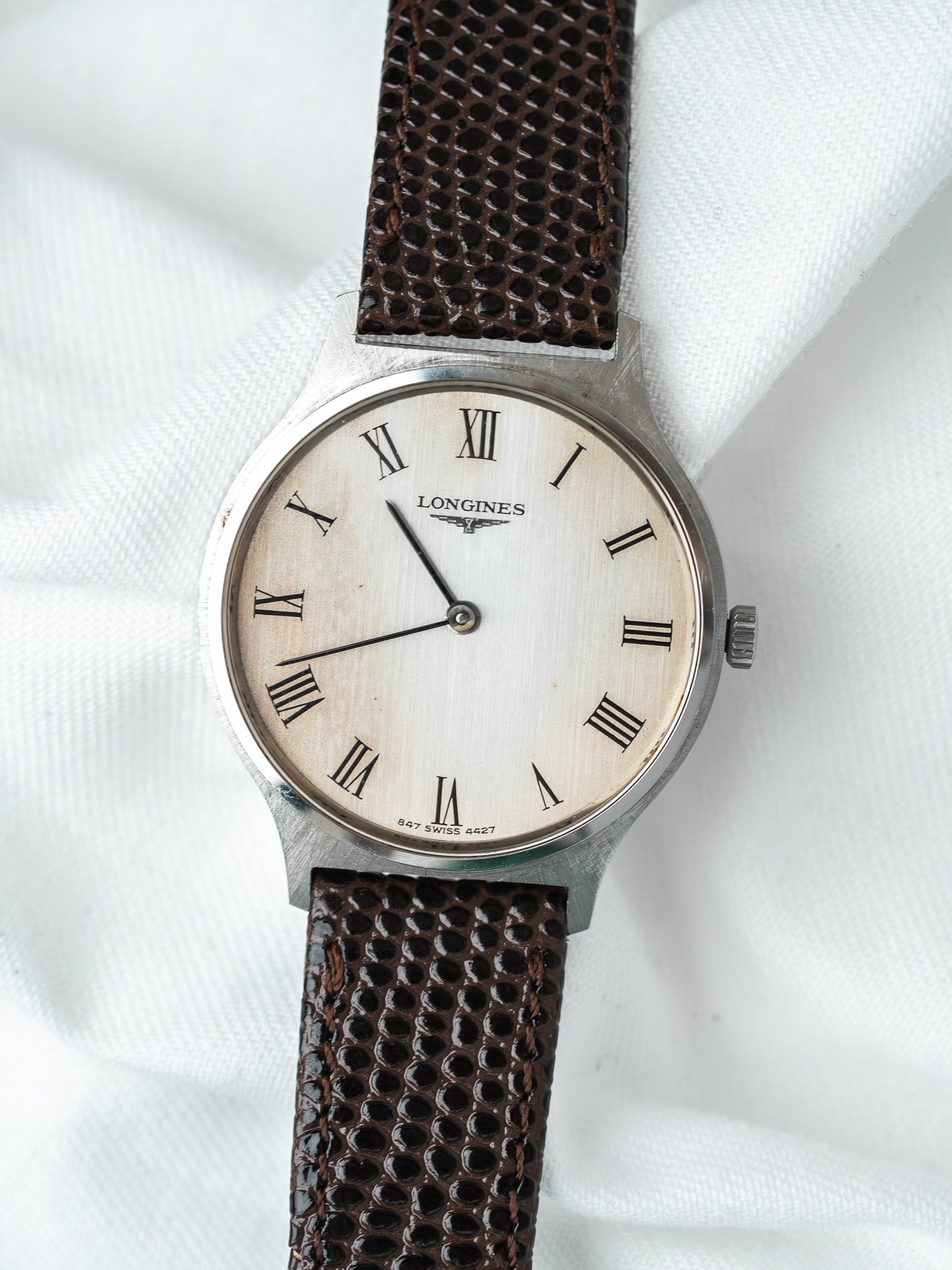 Longines vintage watch with white dial, Roman numerals, brown textured strap