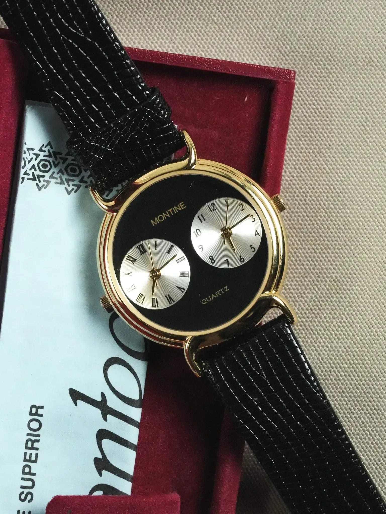 Montine vintage watch with gold case, black dial, dual subdials, and black leather strap