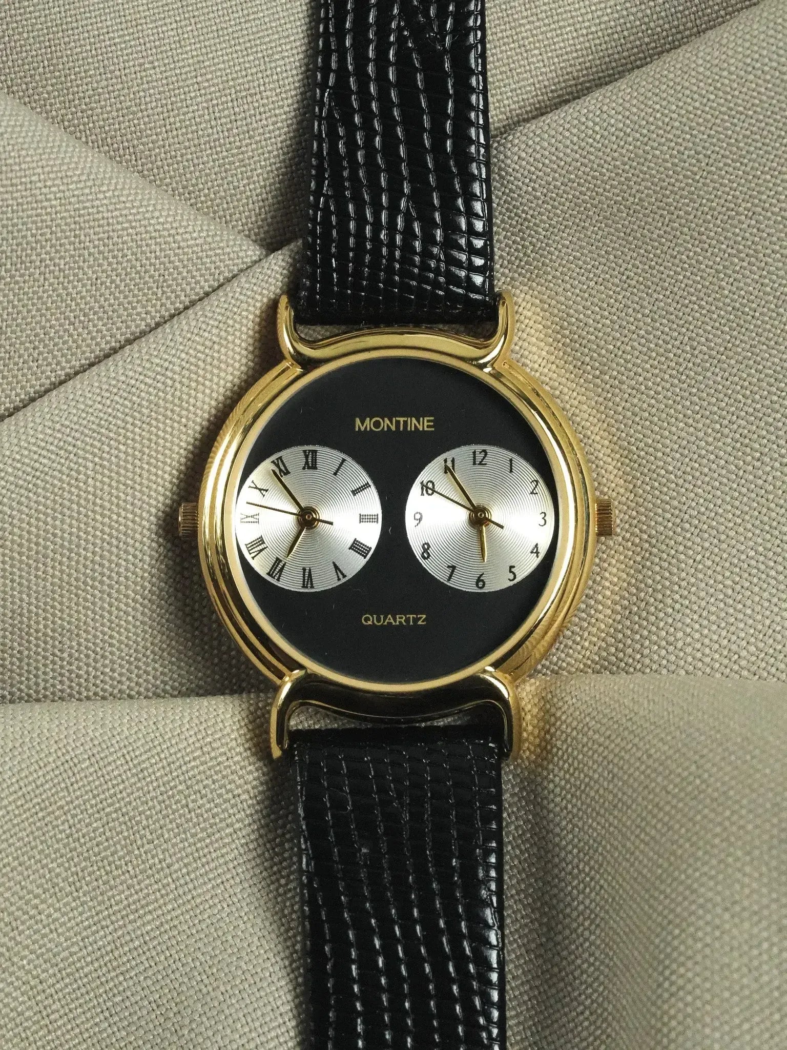 Montine vintage watch with gold case, black dial, dual subdials, and black leather strap