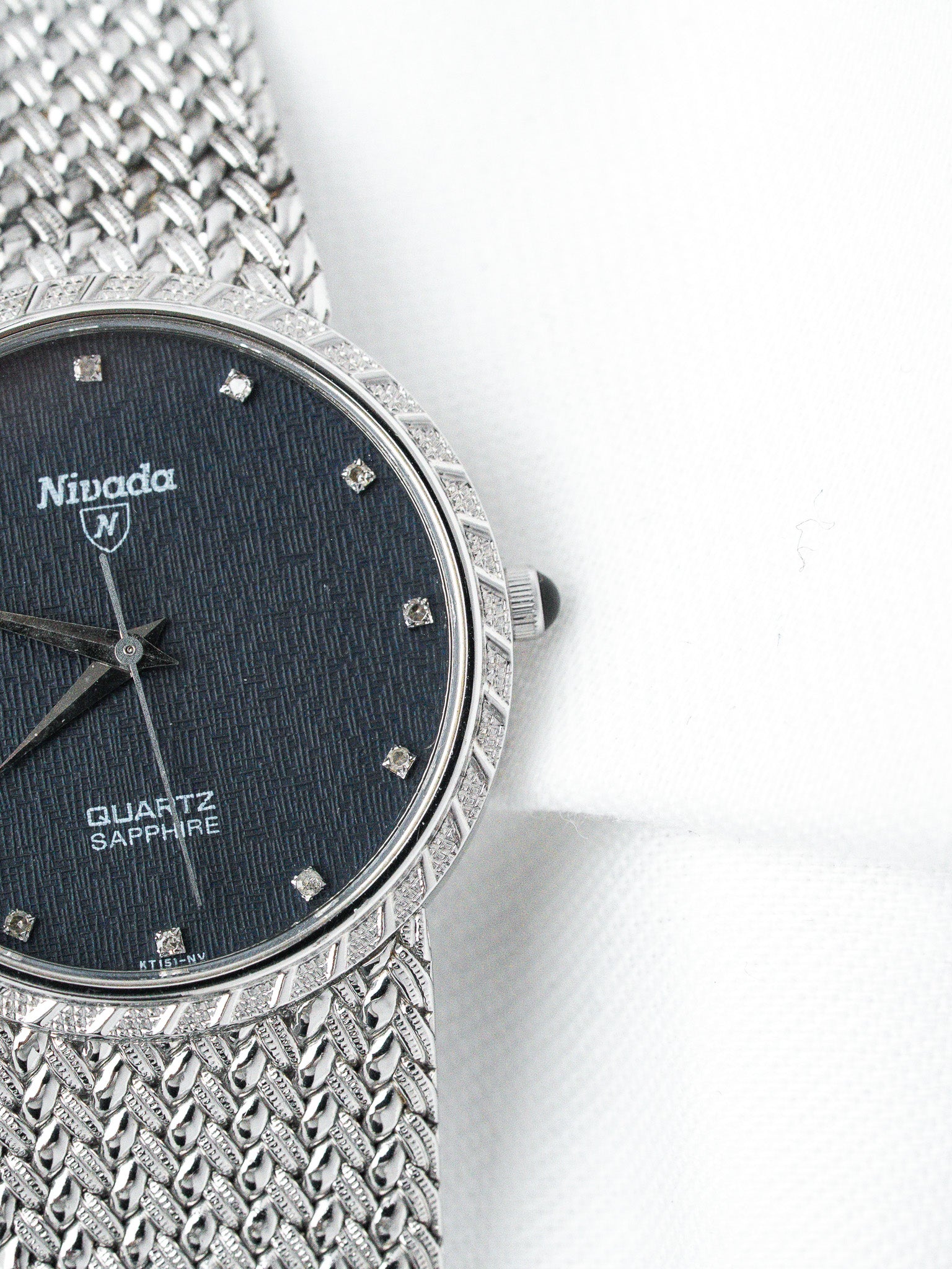 Nivada vintage quartz watch with diamond bezel, dark textured dial, and mesh bracelet