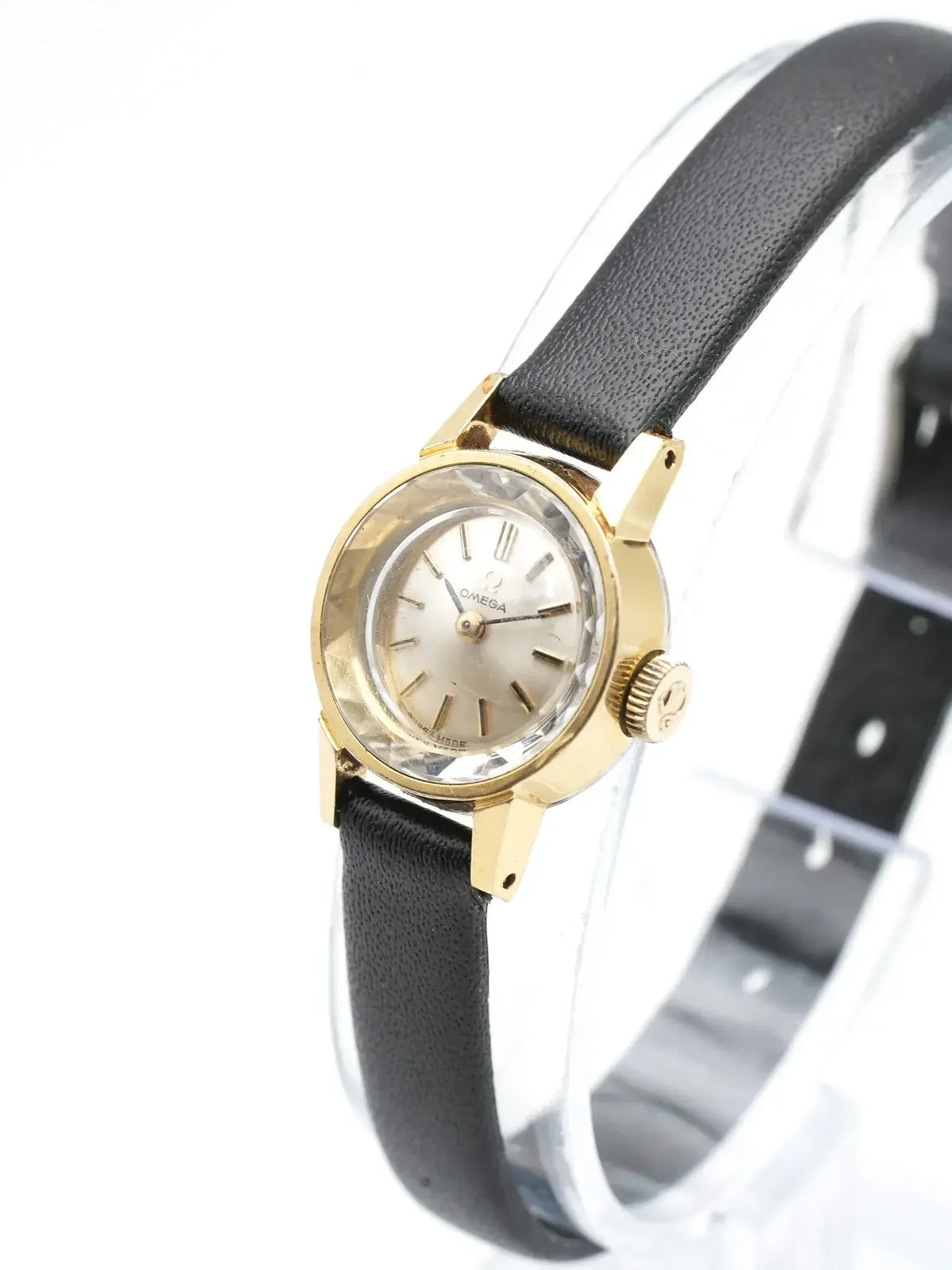 Vintage Omega watch with gold case, silver dial, and black leather strap
