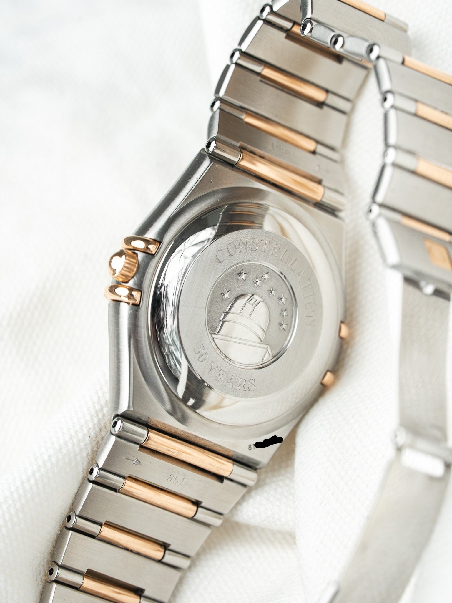 Omega Constellation 30 Years vintage watch back, two-tone steel and gold bracelet on white fabric