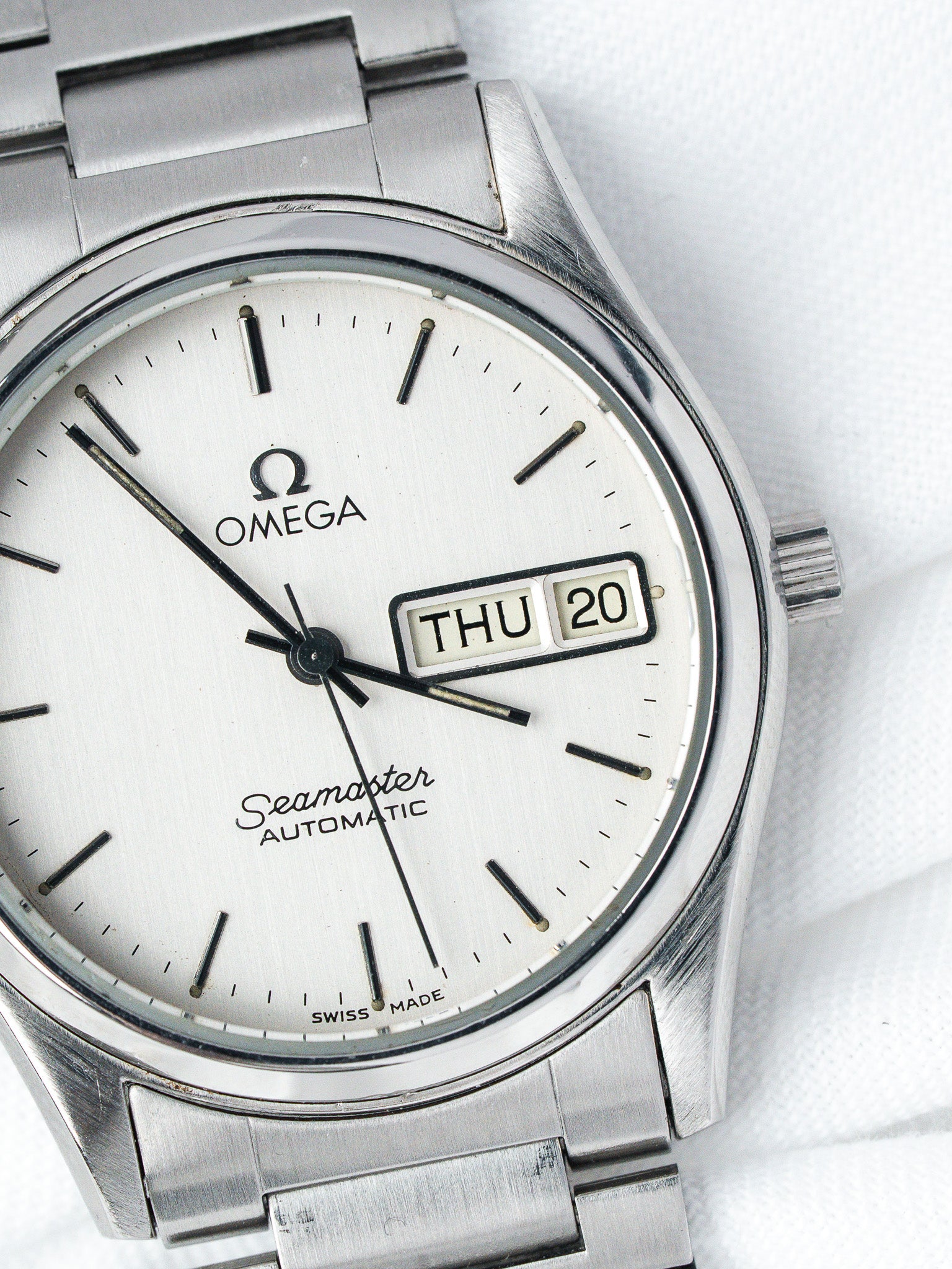Omega Seamaster Automatic vintage watch with silver dial, day-date window, and steel bracelet