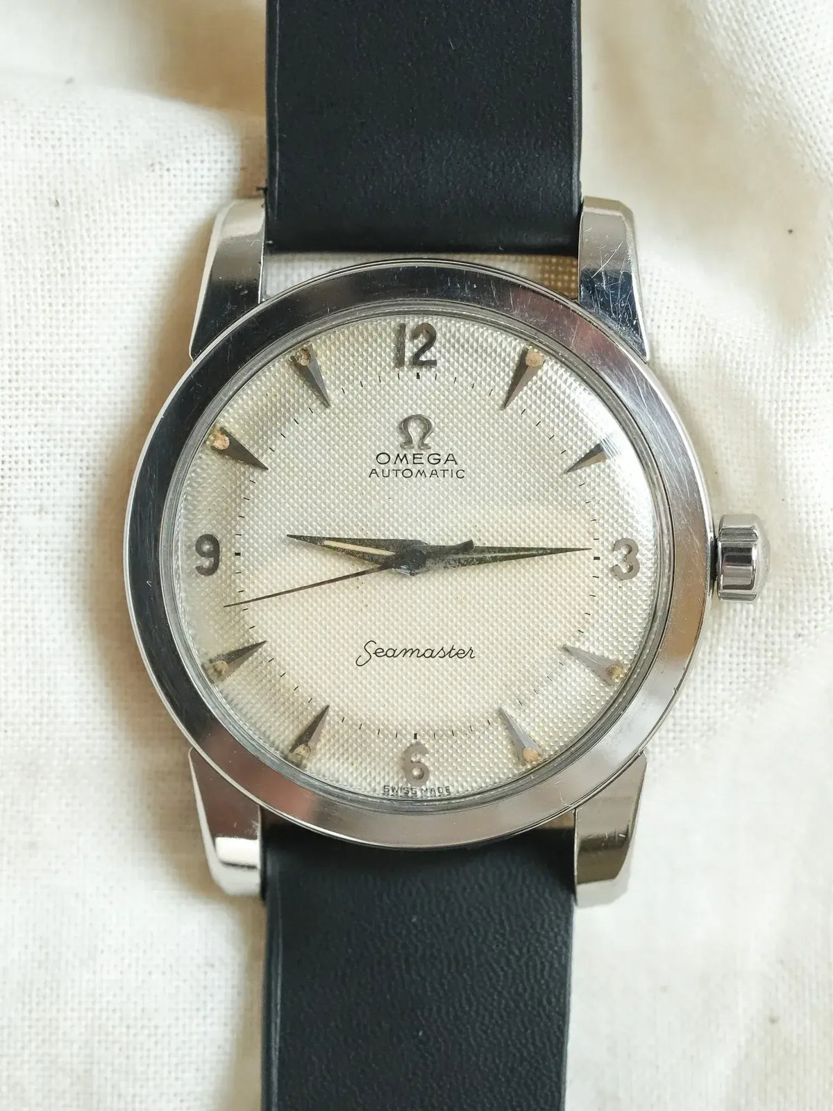 Vintage Omega Seamaster automatic watch with silver textured dial and black leather strap