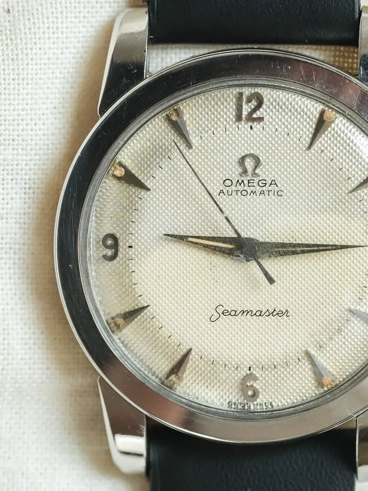 Vintage Omega Seamaster automatic watch with textured silver dial and black leather strap
