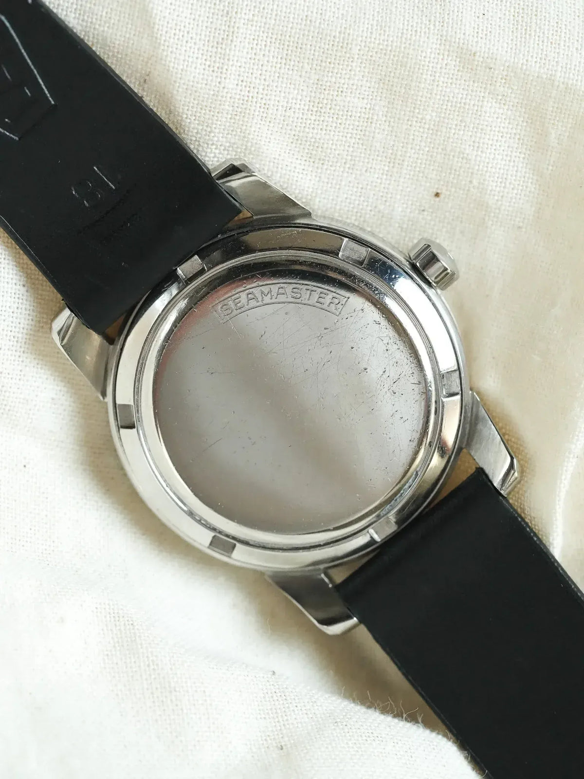 Omega Seamaster vintage watch back, stainless steel case, black rubber strap on fabric