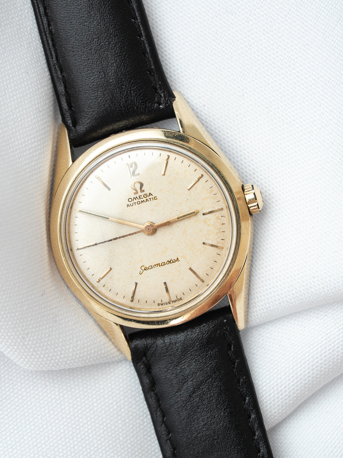 Omega Seamaster vintage watch with gold case, cream dial, black leather strap