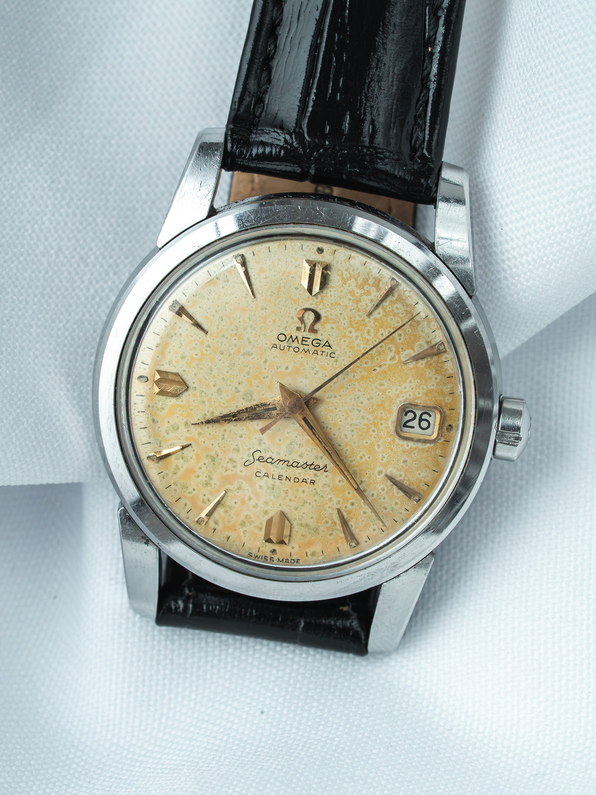 Vintage Omega Seamaster Calendar watch with aged dial, gold markers, black leather strap