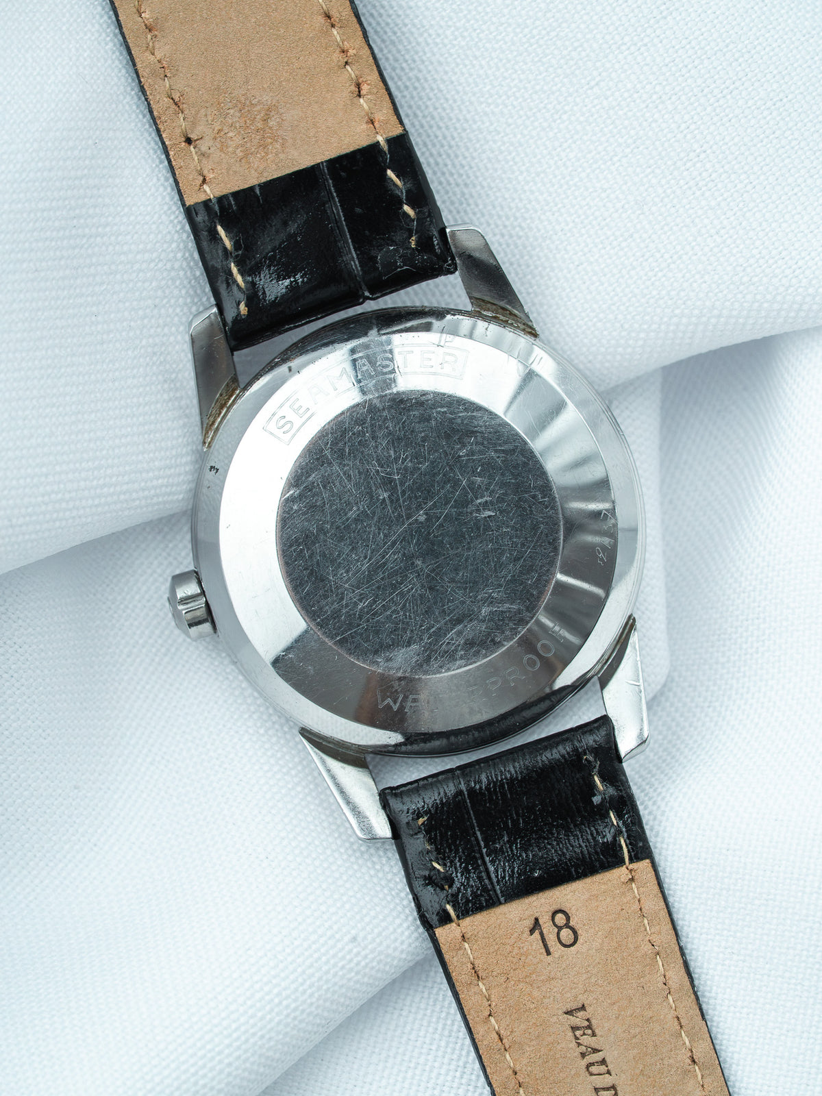 Omega Seamaster vintage watch back, stainless steel case, black leather strap with tan lining