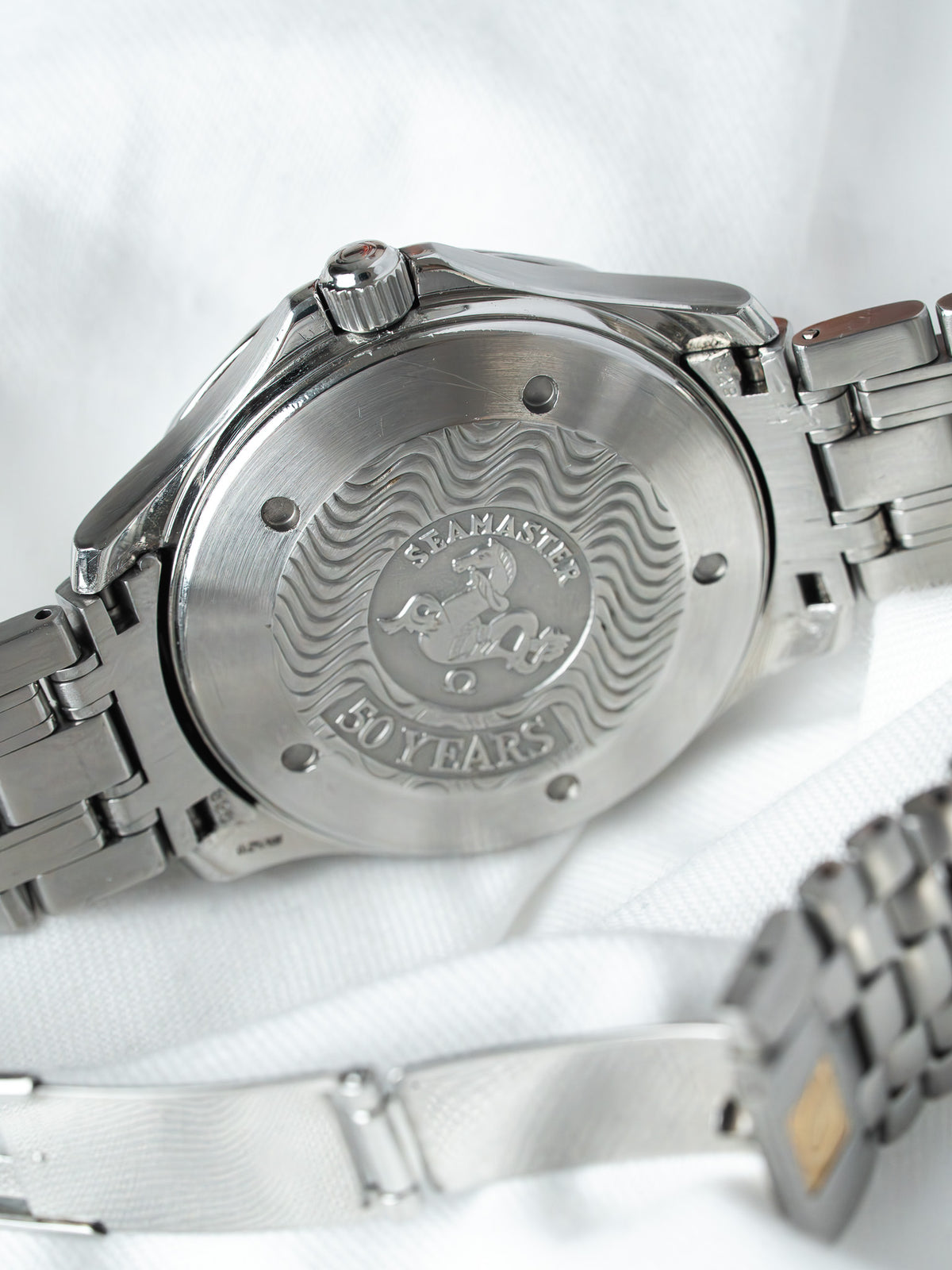 Omega Seamaster 50 Years edition watch back with engraved waves and logo