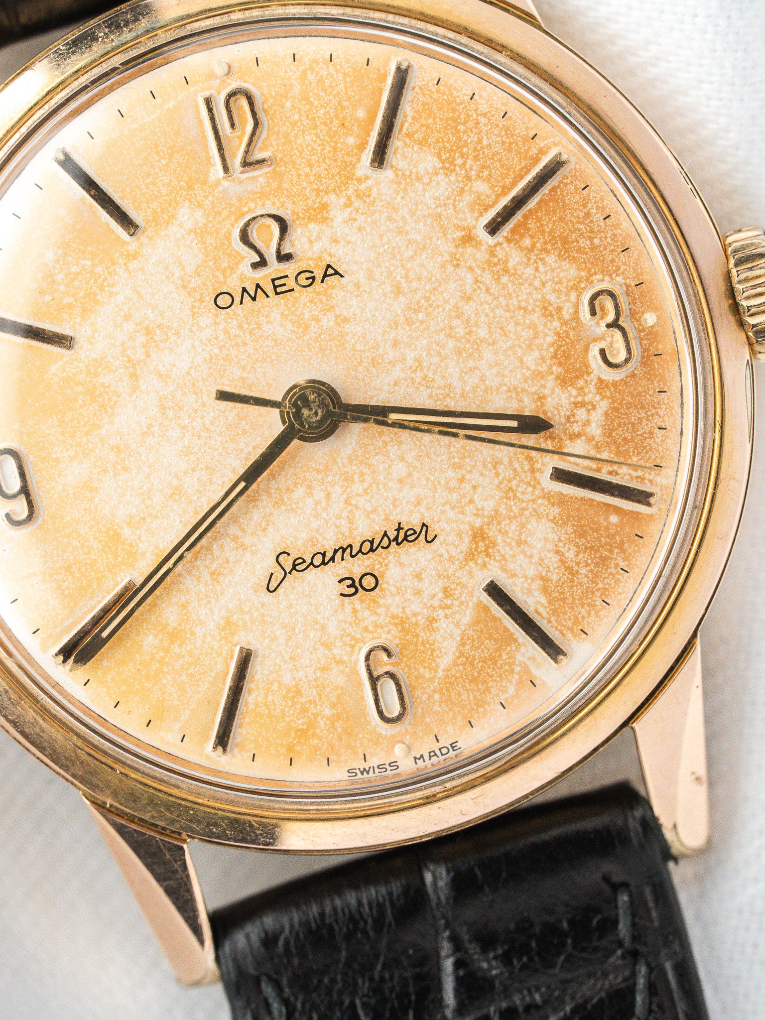 Vintage Omega Seamaster 30 watch with aged dial and black leather strap