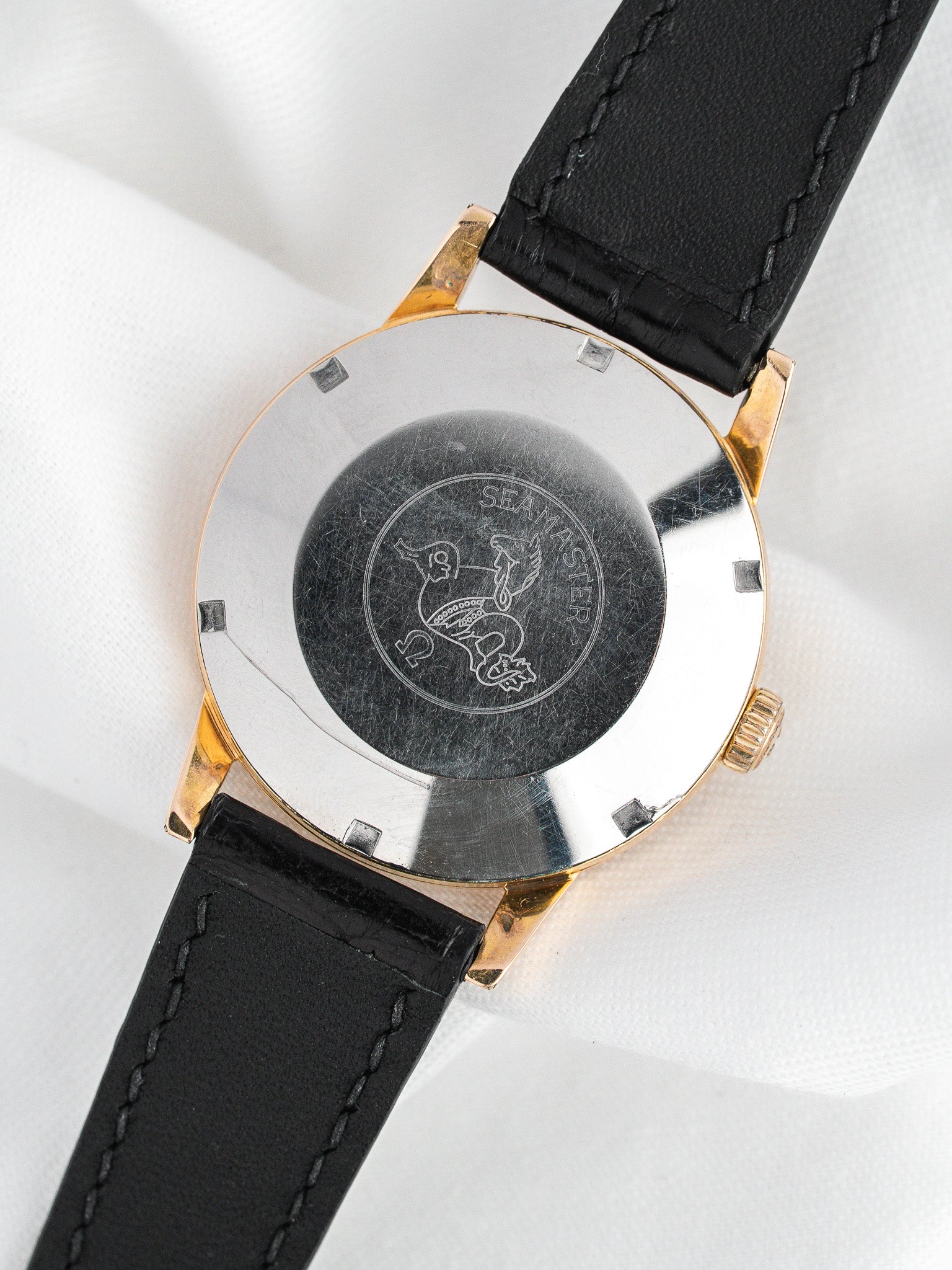 Omega Seamaster vintage watch with engraved case back and black leather strap