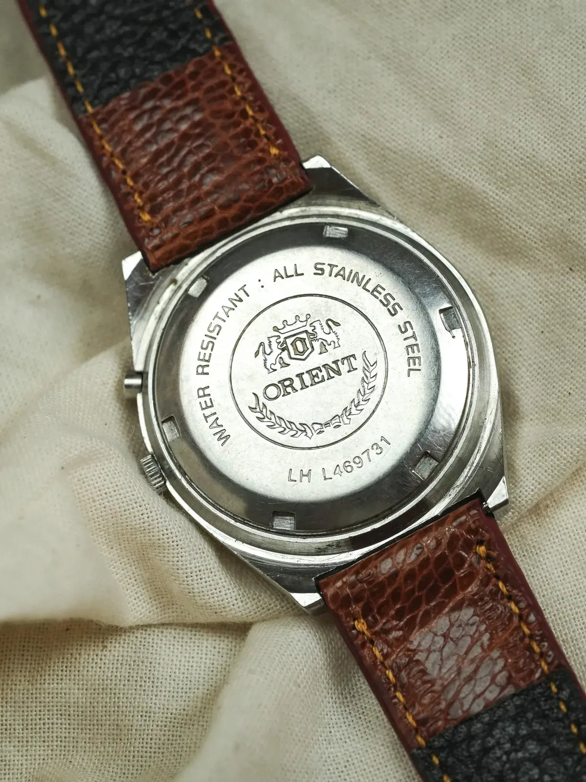Orient vintage watch back, stainless steel case, brown textured leather strap