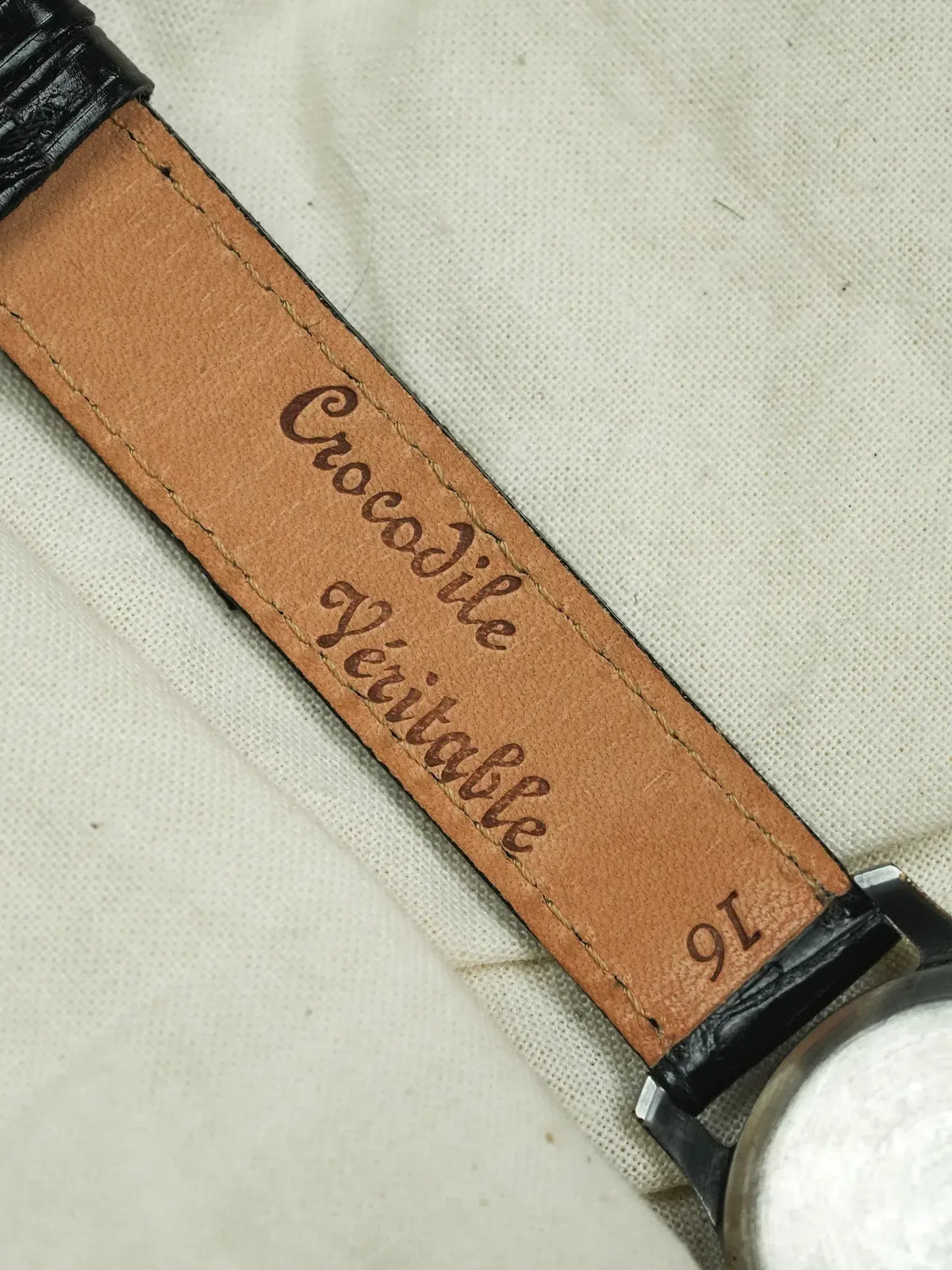 Genuine crocodile leather watch strap with embossed text, tan interior, black exterior