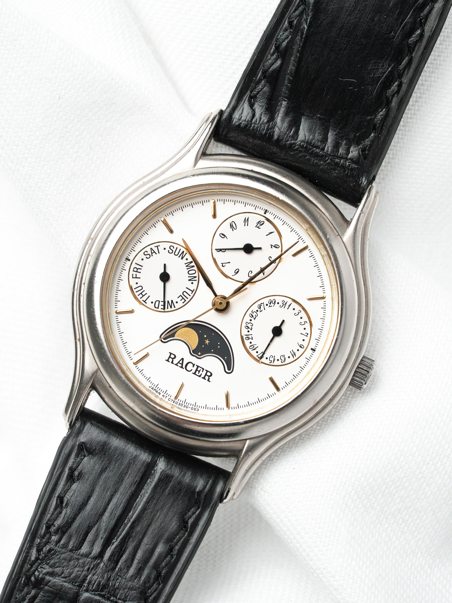 Racer vintage watch with white dial, moon phase, black leather strap, and day-date subdials