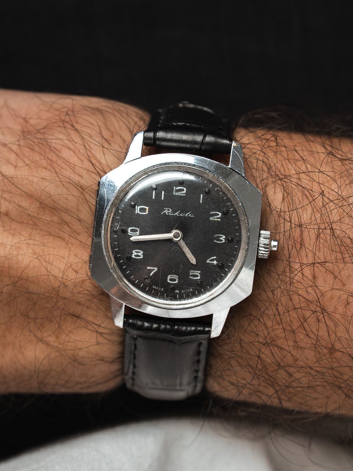 Montre Raketa vintage au boîtier octogonal, cadran noir et bracelet cuir noir