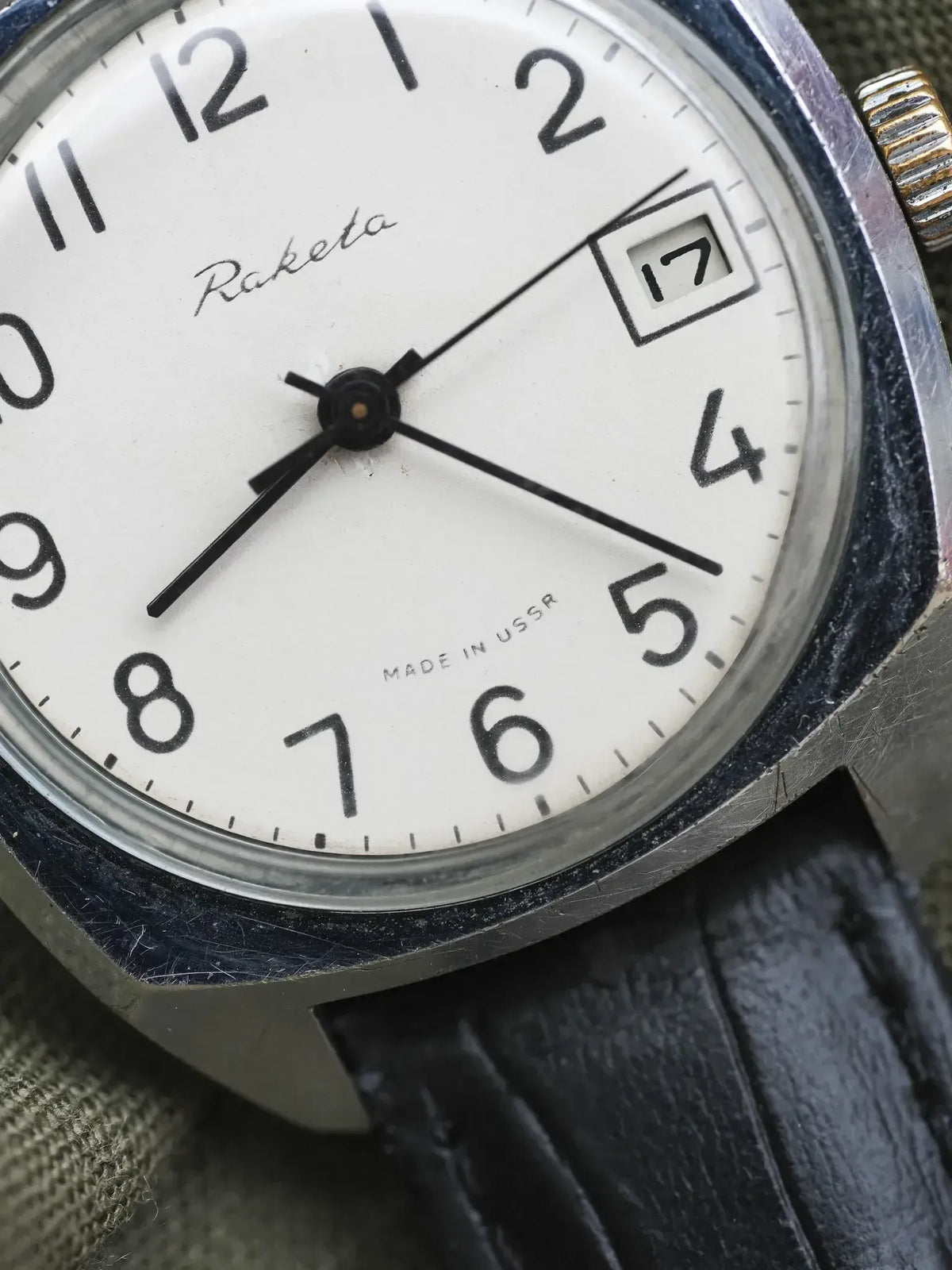 Raketa vintage watch with white dial, black numerals, and date window, USSR-made