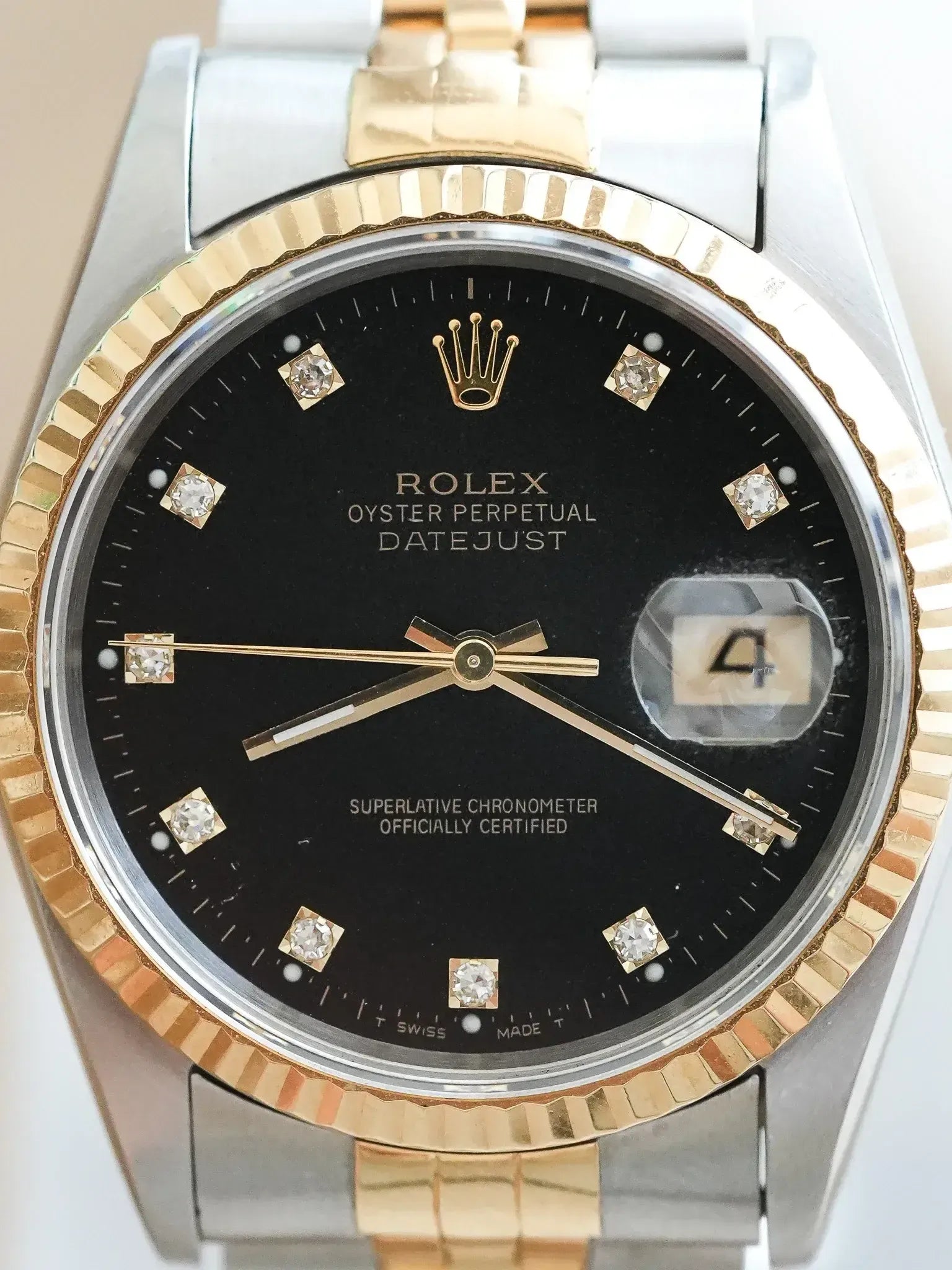 Rolex Datejust vintage with black dial, diamond hour markers, gold bezel and two-tone bracelet