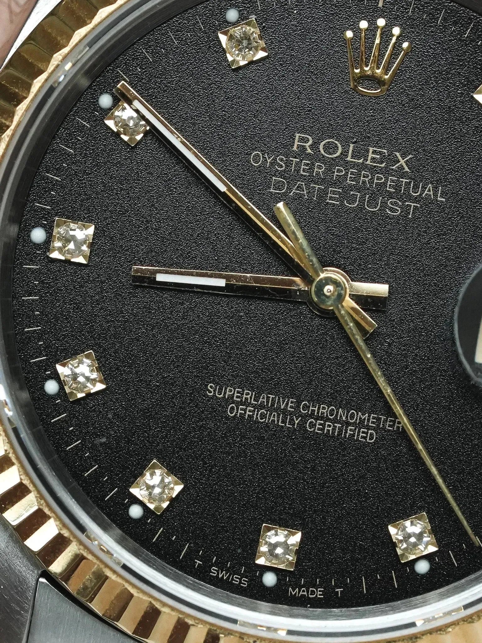 Rolex Datejust vintage with black dial, diamond hour markers, and gold hands