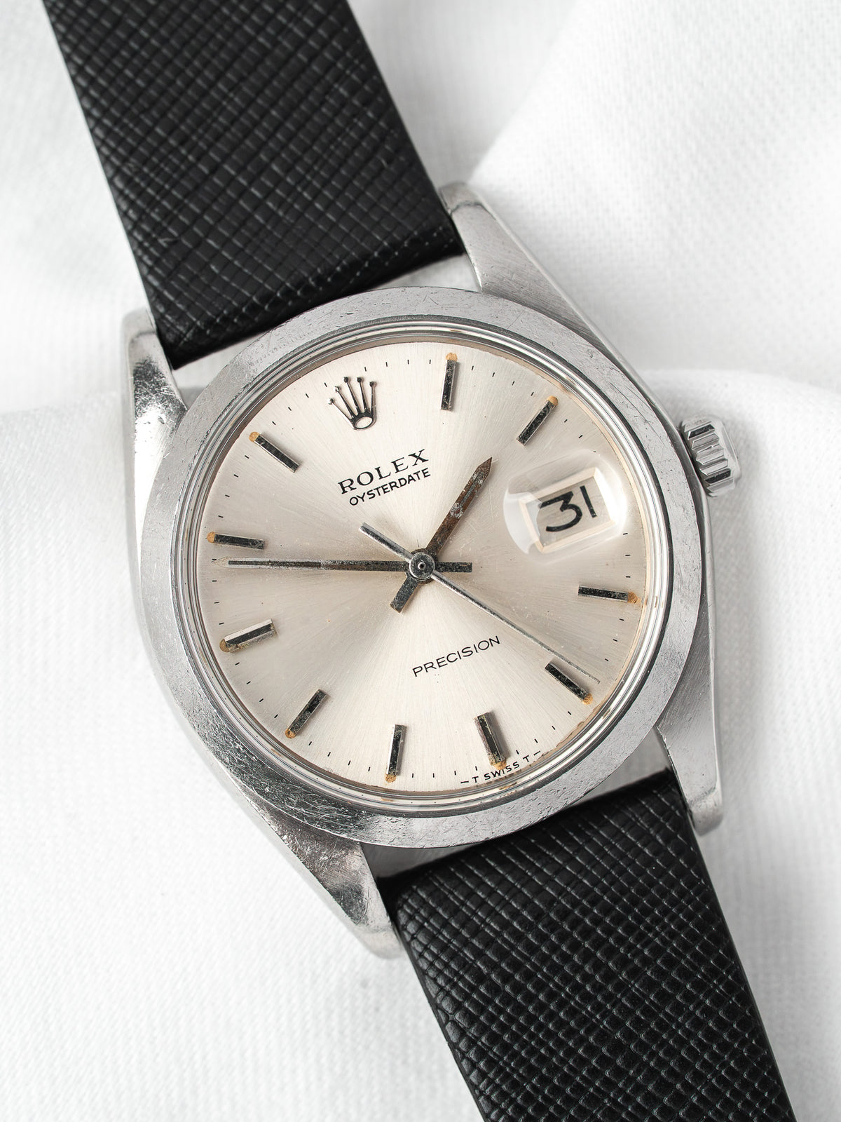 Rolex Oysterdate vintage watch with silver dial and black textured strap