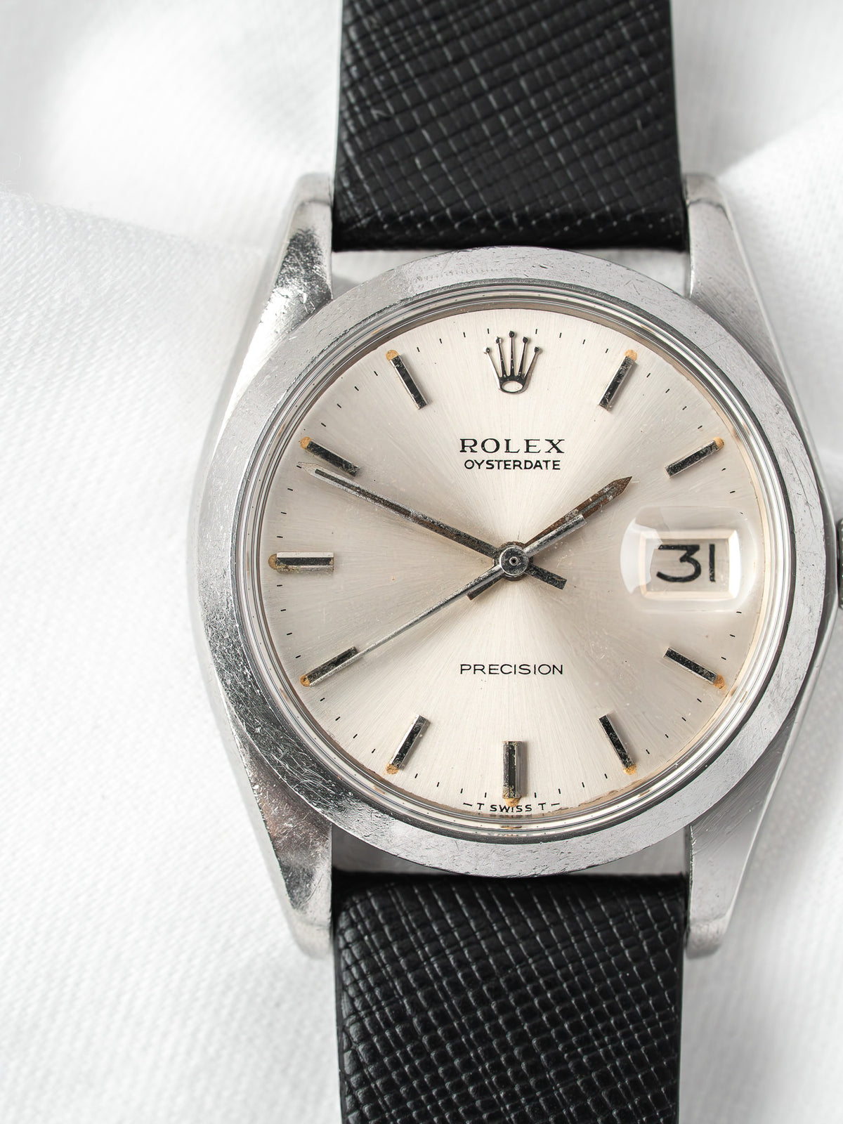 Rolex Oysterdate vintage watch with silver dial and black textured strap