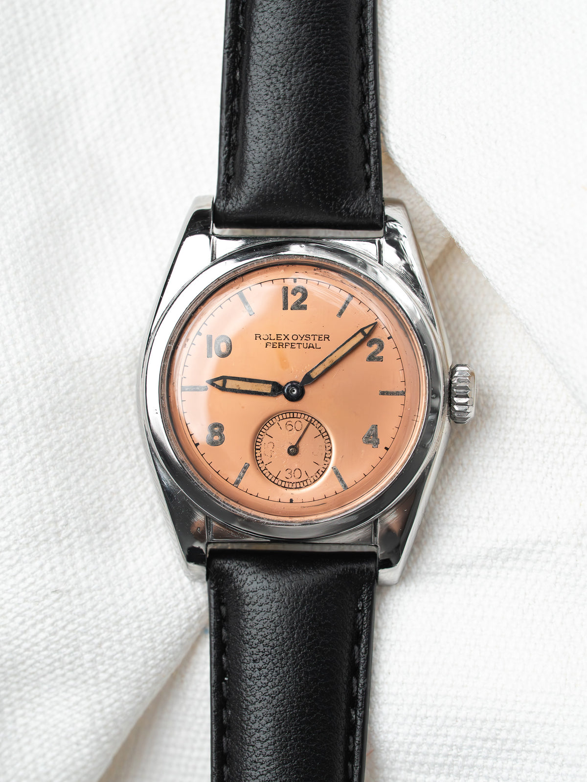 Rolex Oyster Perpetual vintage watch with salmon dial, black leather strap, steel case