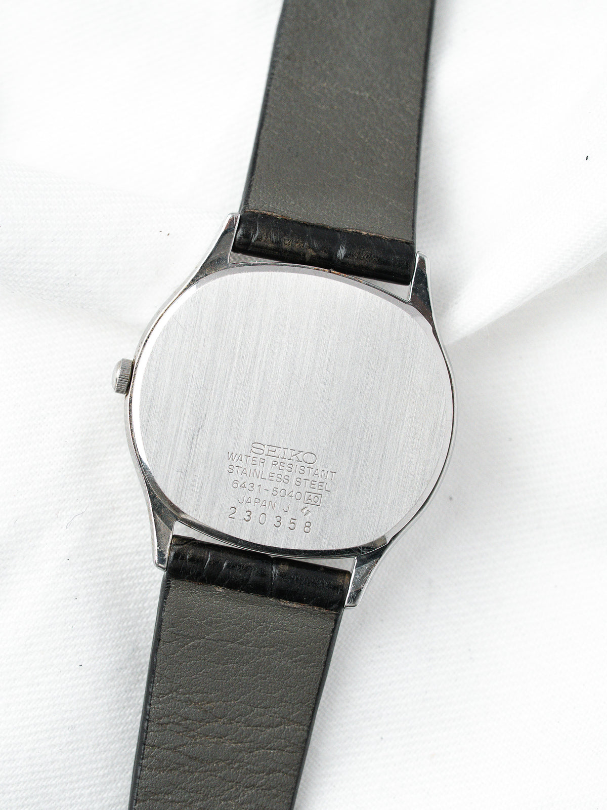 Seiko vintage watch back with stainless steel case and black leather strap