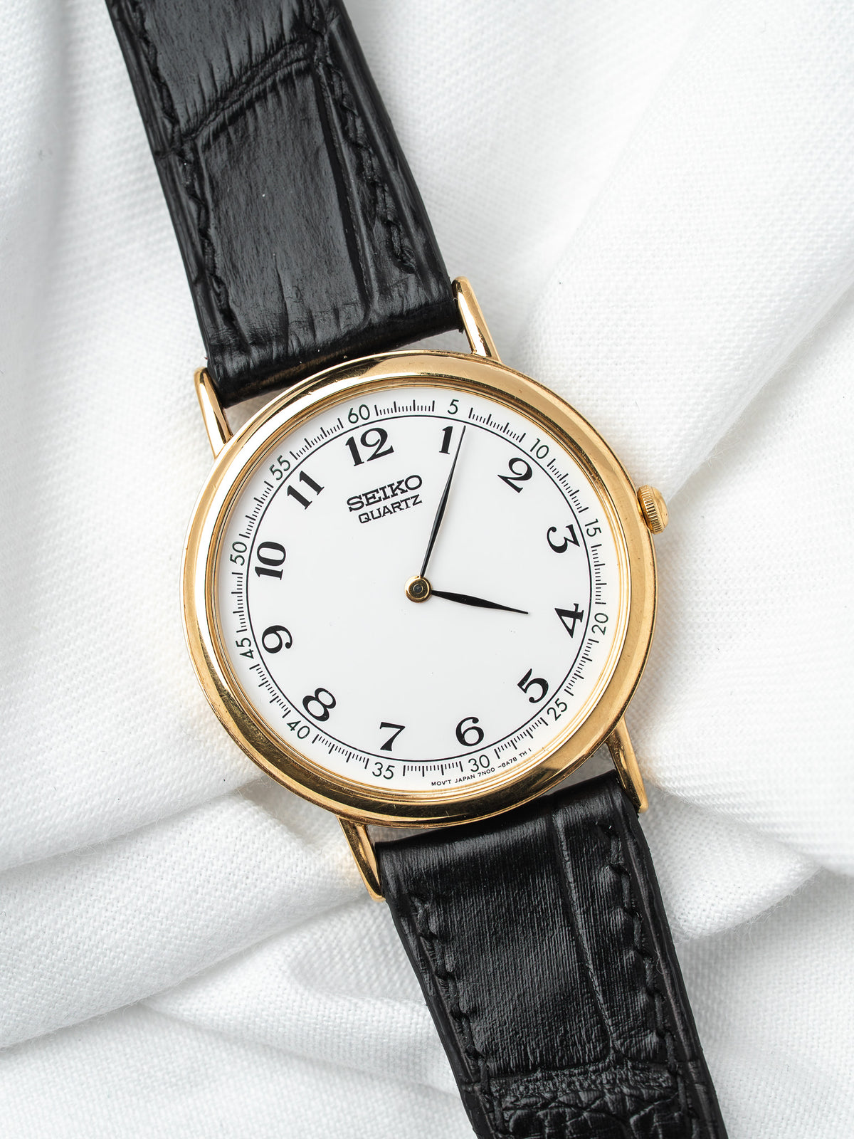 Seiko Quartz vintage watch with gold case, white dial, black leather strap