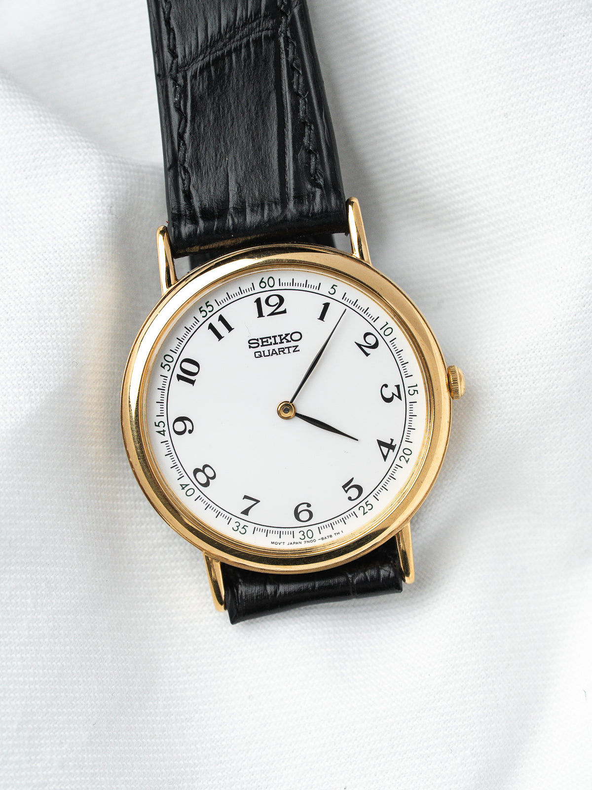 Seiko Quartz vintage watch with gold case, white dial, black leather strap