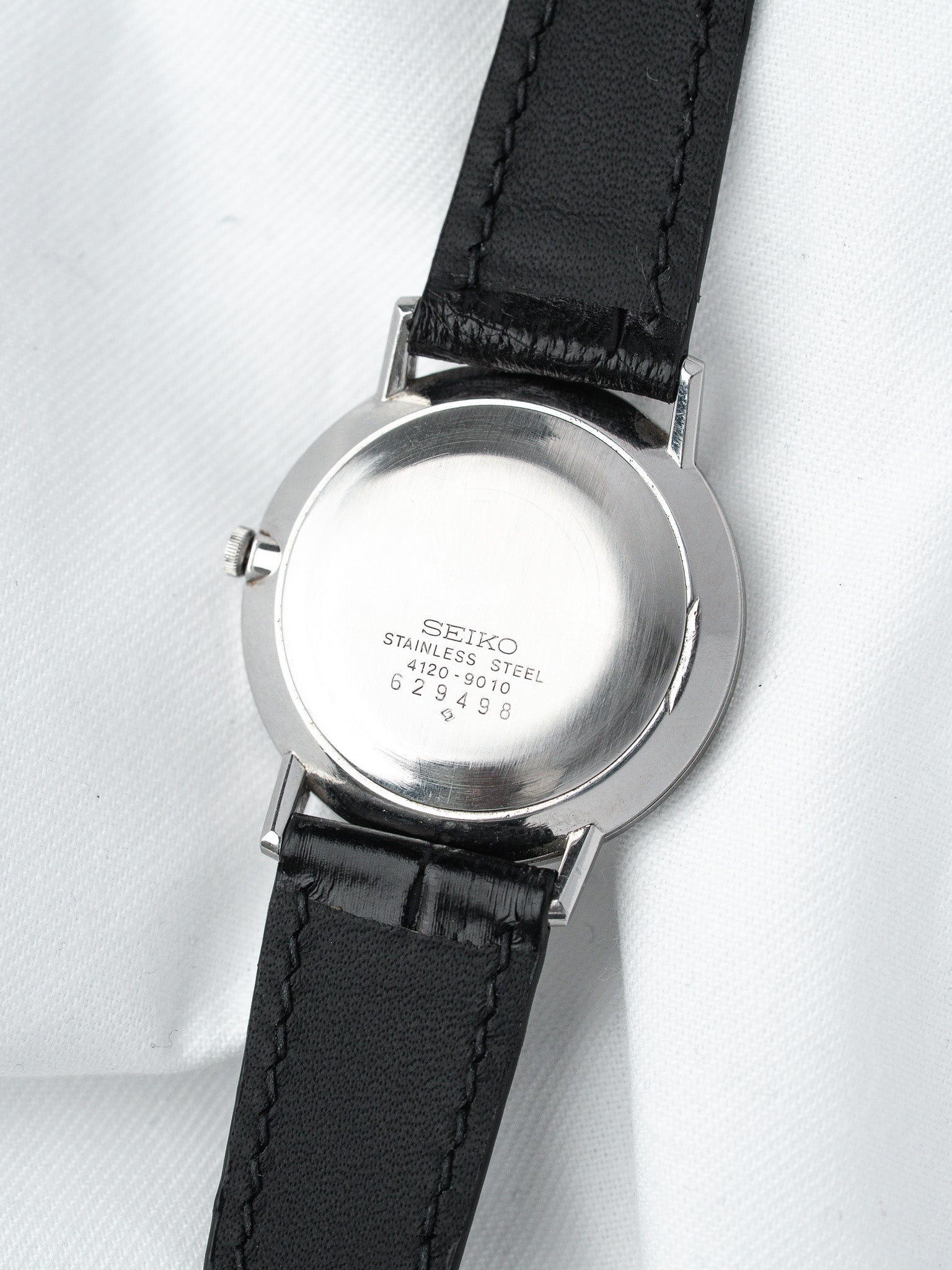 Seiko vintage stainless steel watch back with black leather strap