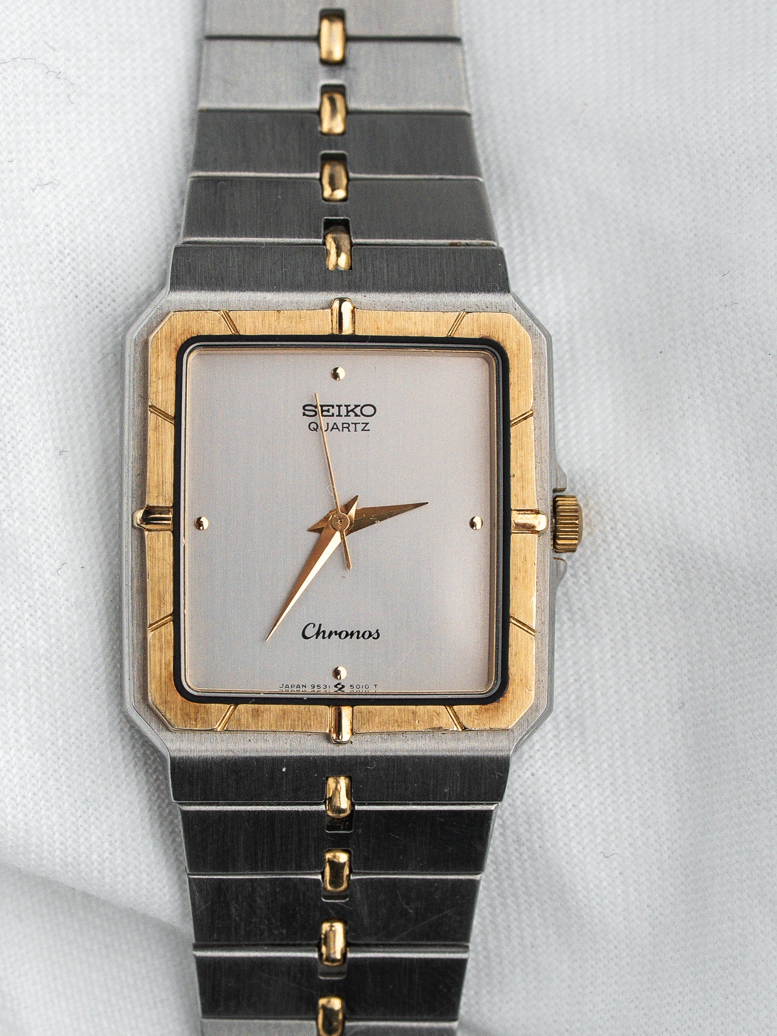 Seiko Chronos vintage watch with gold accents and silver dial on textured background