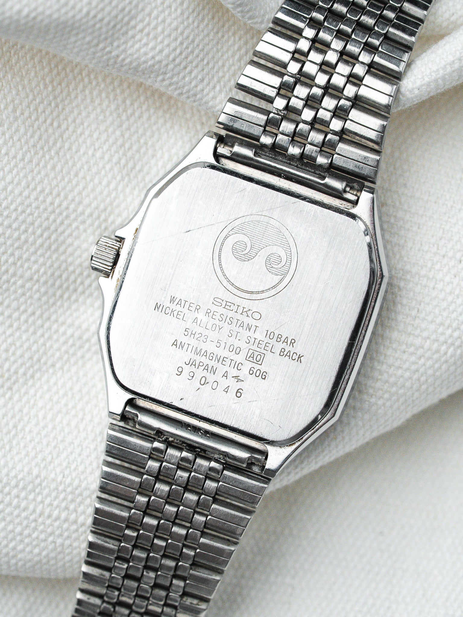 Seiko vintage watch back with engraved specs, stainless steel case and mesh bracelet