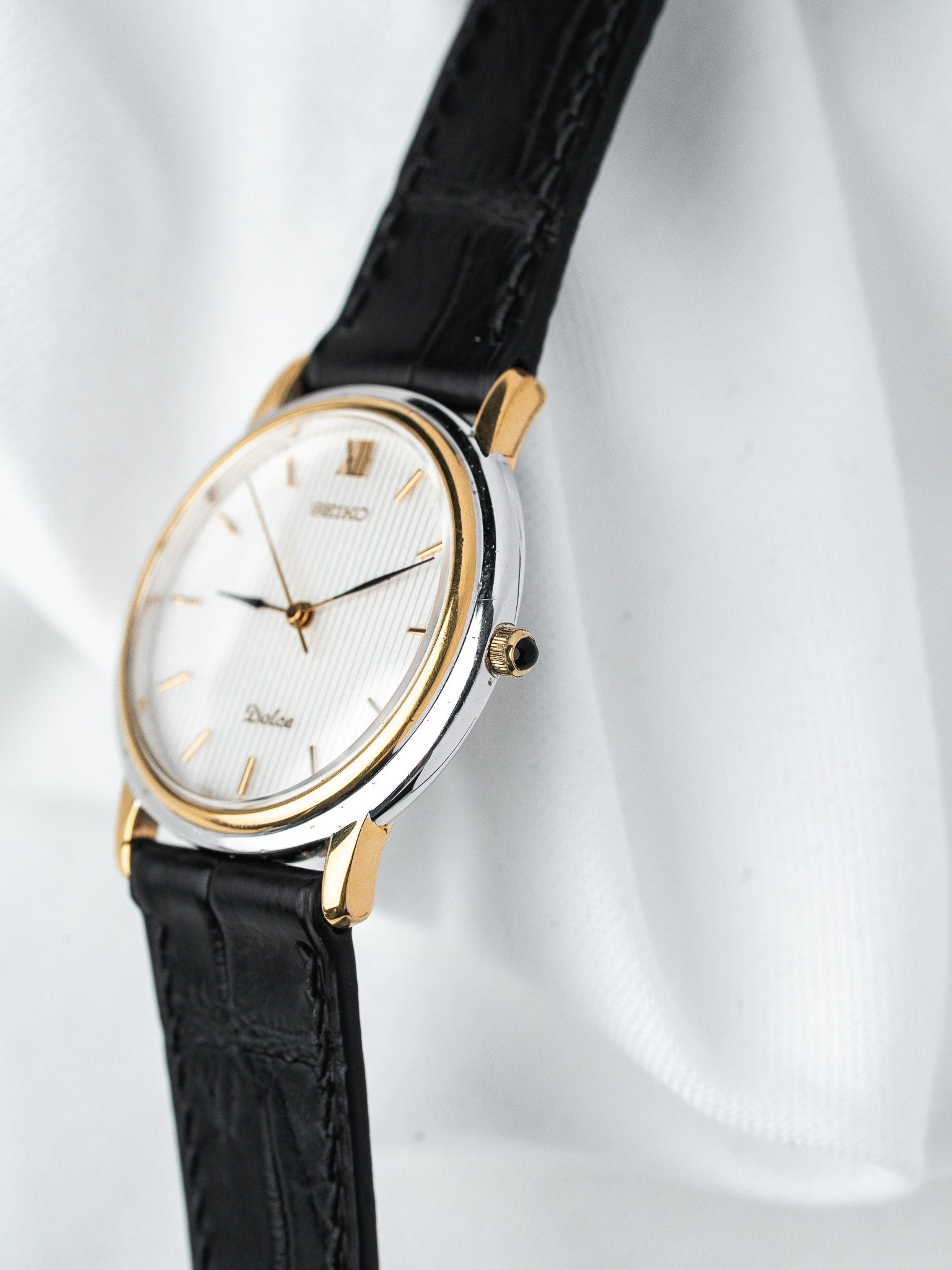Seiko Dolce vintage watch with white dial, gold accents, black leather strap