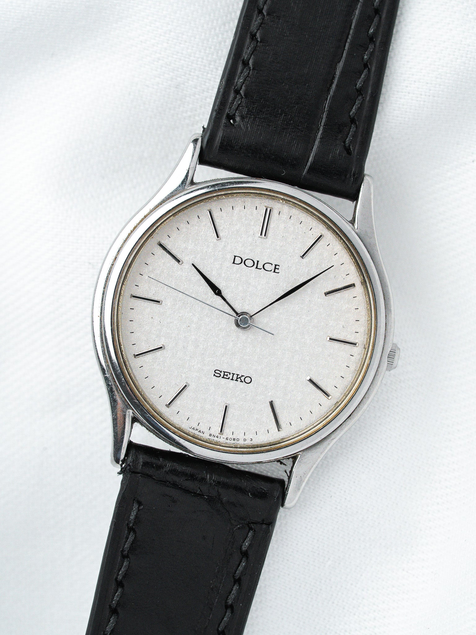 Seiko Dolce vintage watch with silver dial, black leather strap, and steel case