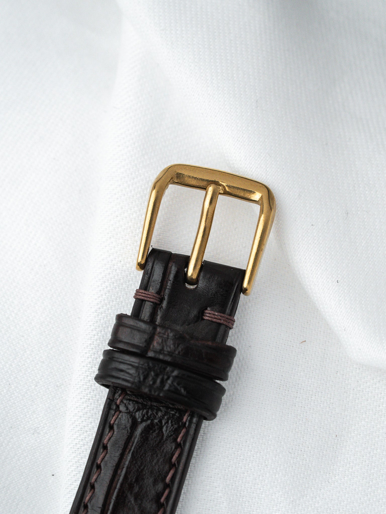 Vintage watch strap with dark brown leather and gold buckle