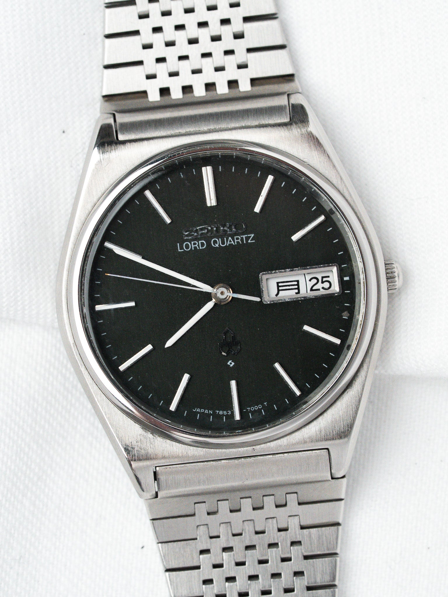 Seiko Lord Quartz vintage watch with black dial, silver markers, and mesh bracelet
