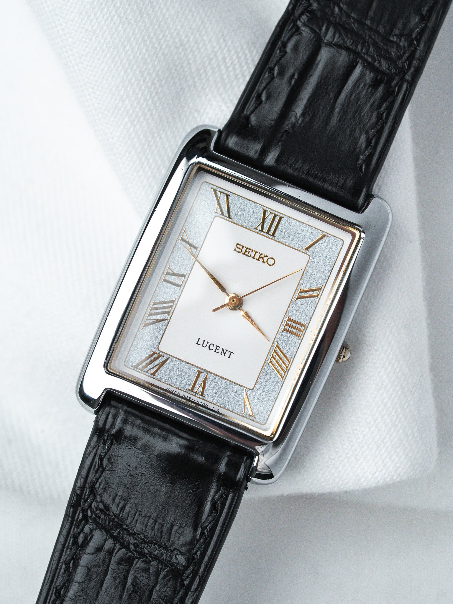 Seiko Lucent vintage watch with silver dial, Roman numerals, black leather strap