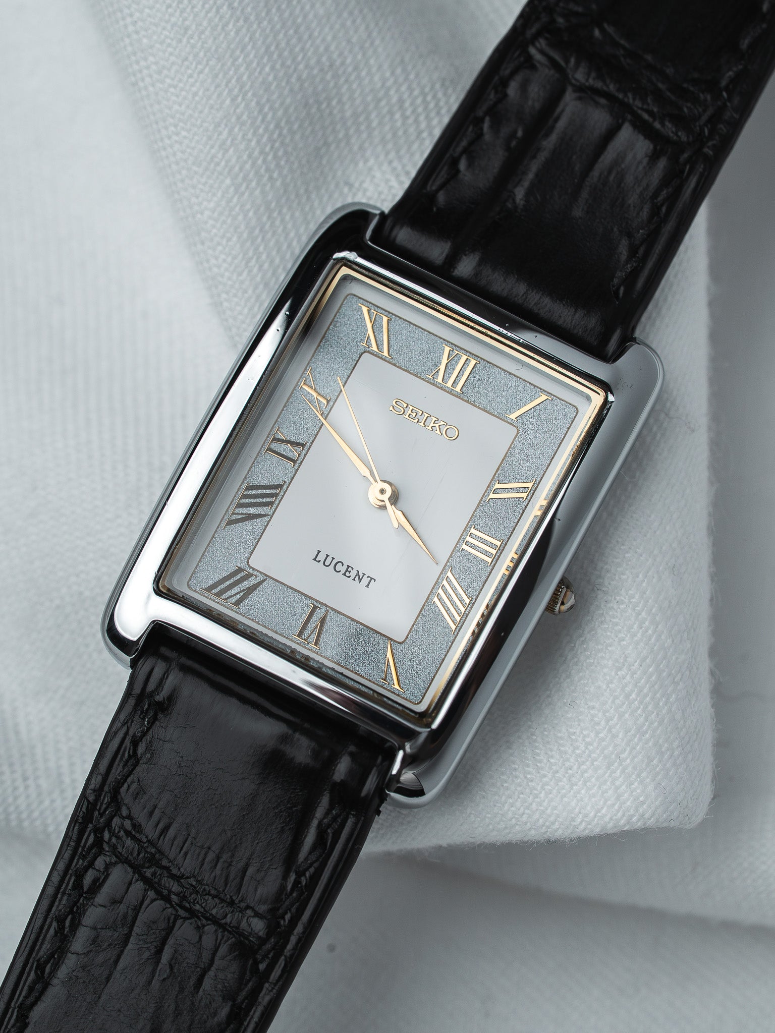 Seiko Lucent vintage watch with silver dial, Roman numerals, black leather strap