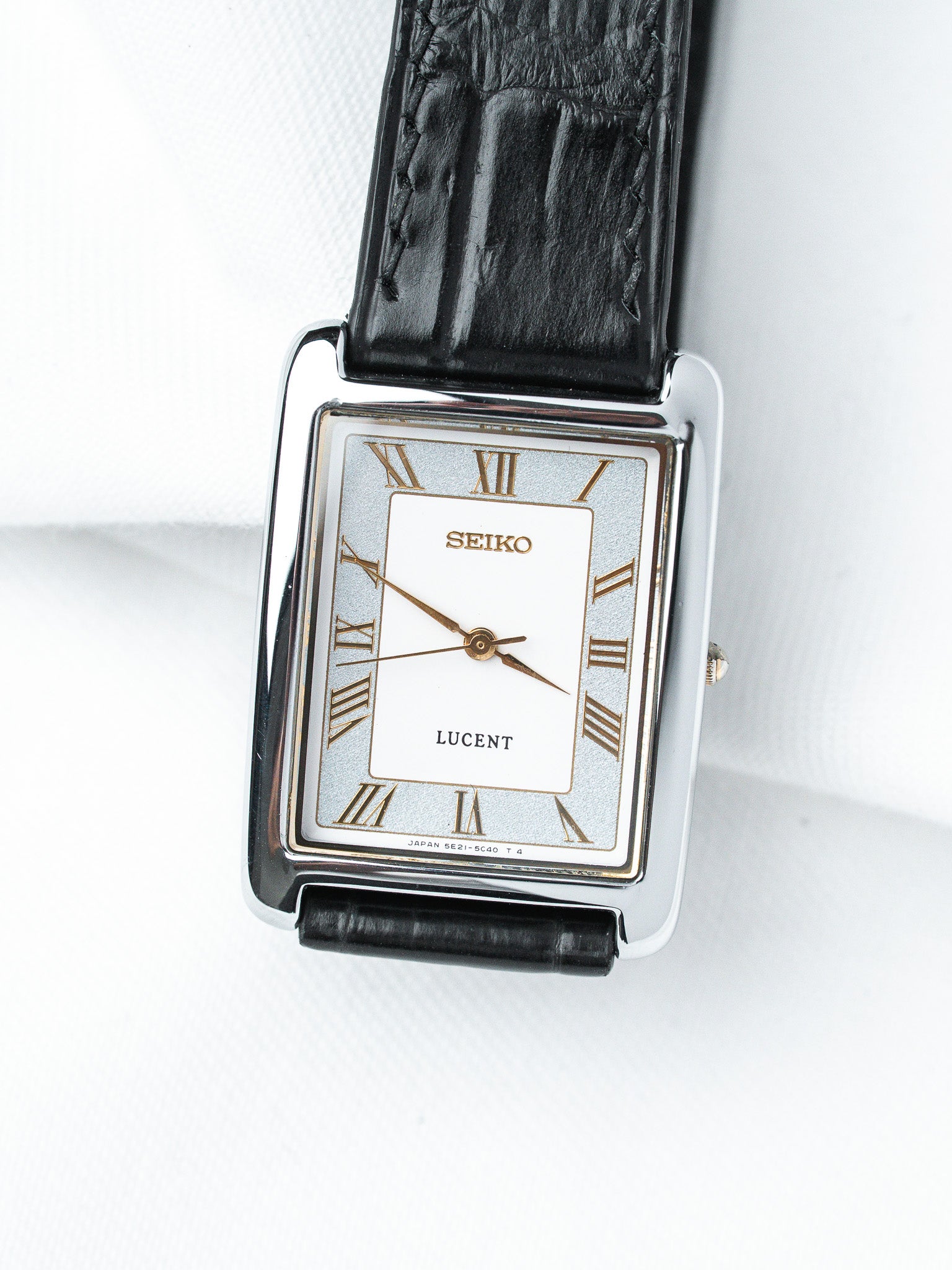 Seiko Lucent vintage watch with rectangular case, white dial, Roman numerals, black leather strap
