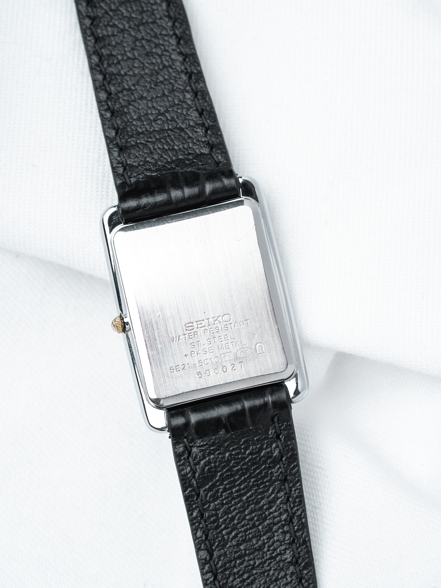 Seiko vintage watch with rectangular stainless steel case and black leather strap