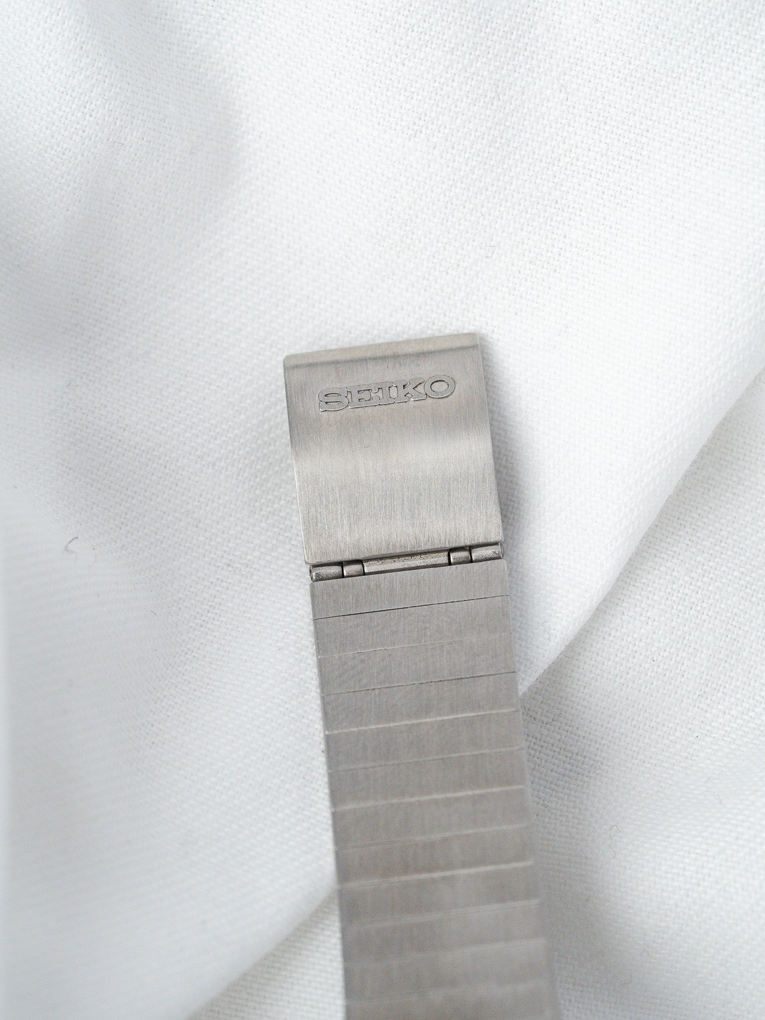 Seiko vintage watch bracelet in brushed stainless steel, clasp engraved with brand name