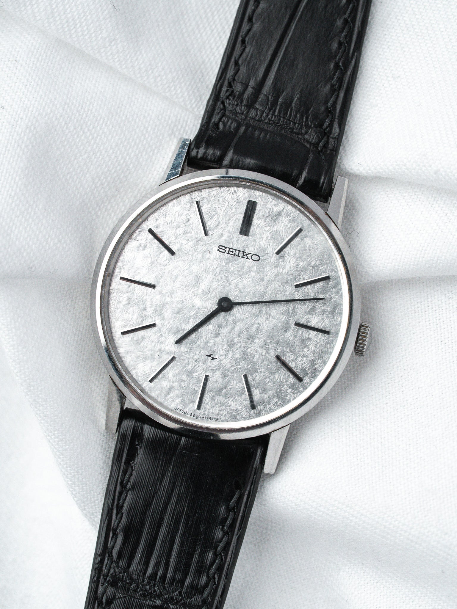 Seiko vintage watch with textured silver dial and black leather strap