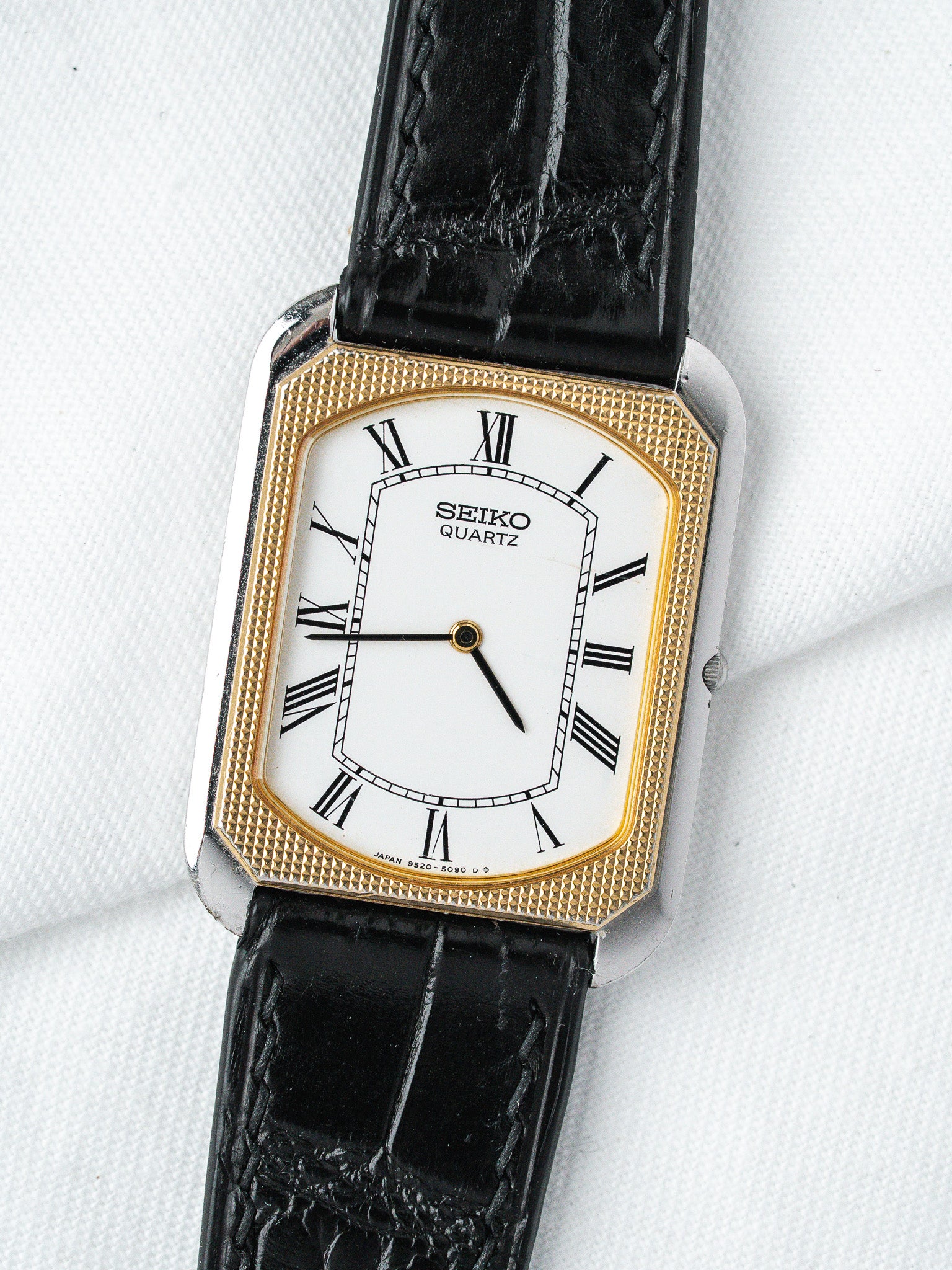 Seiko Quartz vintage watch with gold bezel, white dial, black leather strap