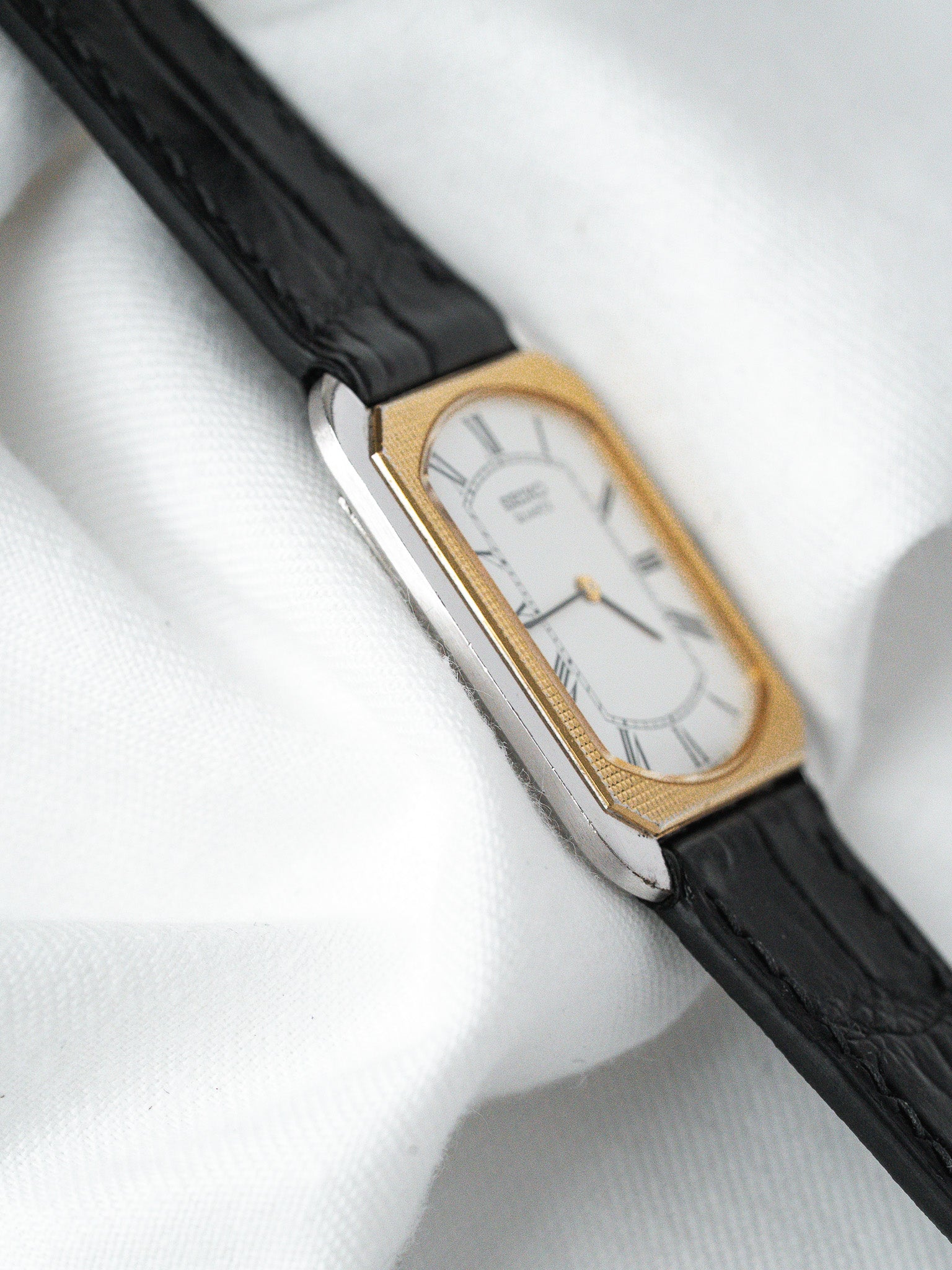 Cartier Tank vintage watch with gold bezel, white dial, black leather strap