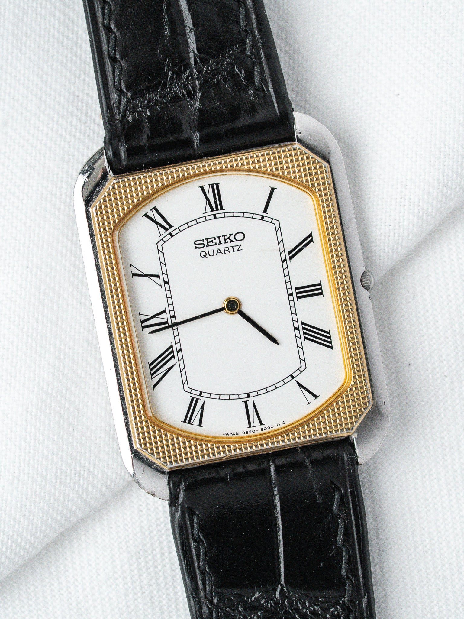 Seiko Quartz vintage watch with gold bezel, white dial, black leather strap