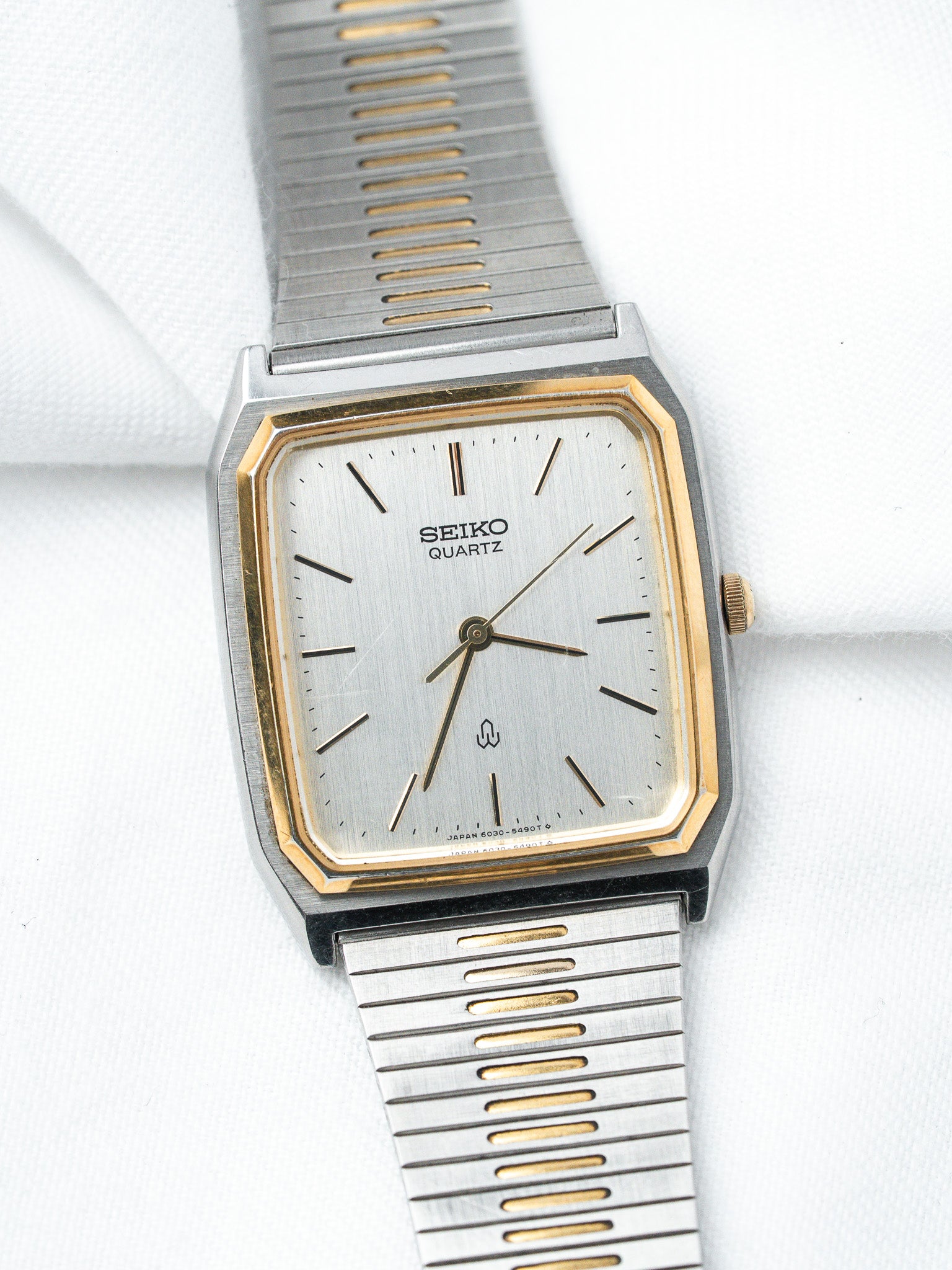 Seiko Quartz vintage watch with silver dial, gold accents, and two-tone metal bracelet