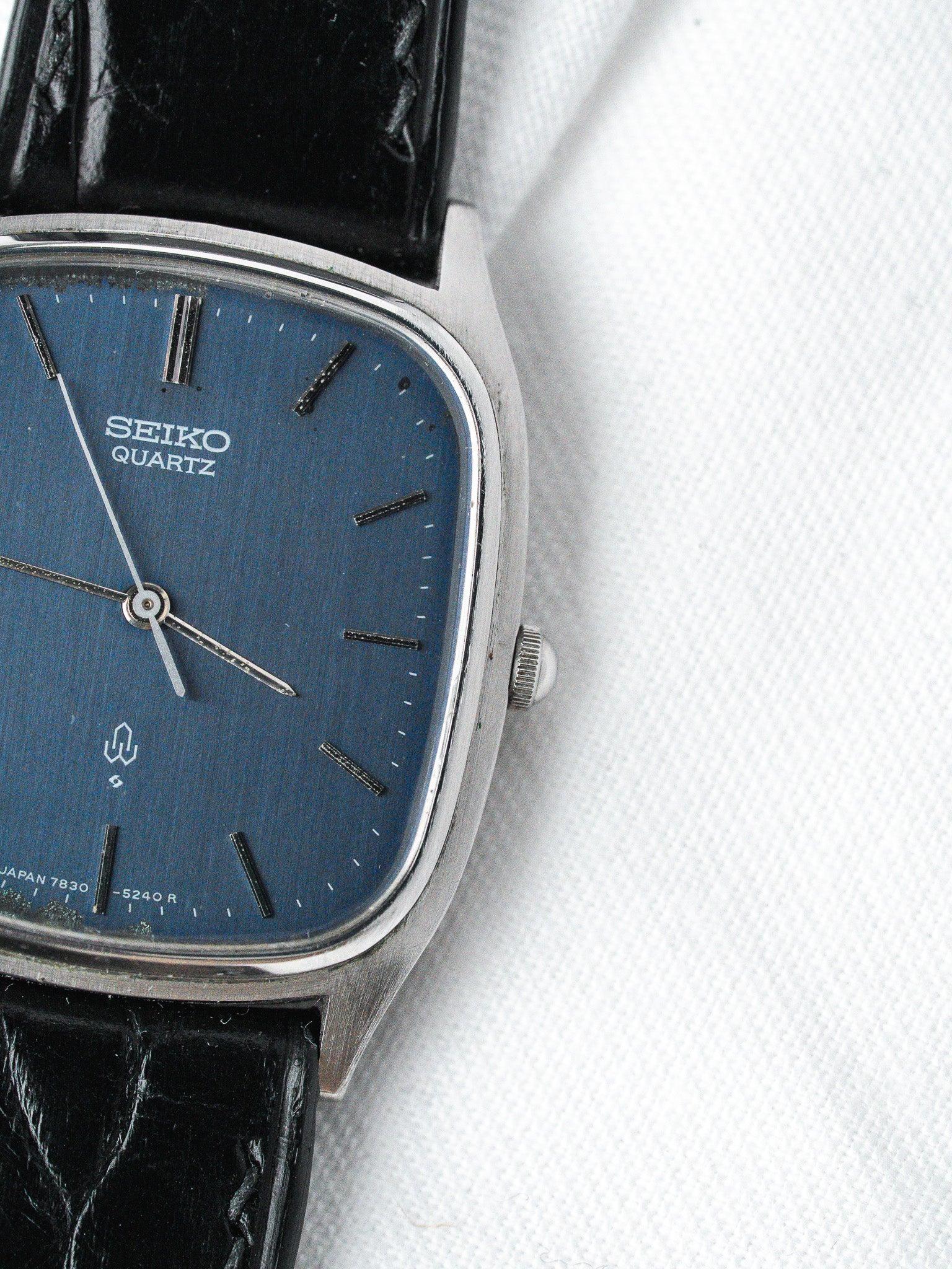 Seiko Quartz vintage watch with blue dial, black leather strap, and silver case